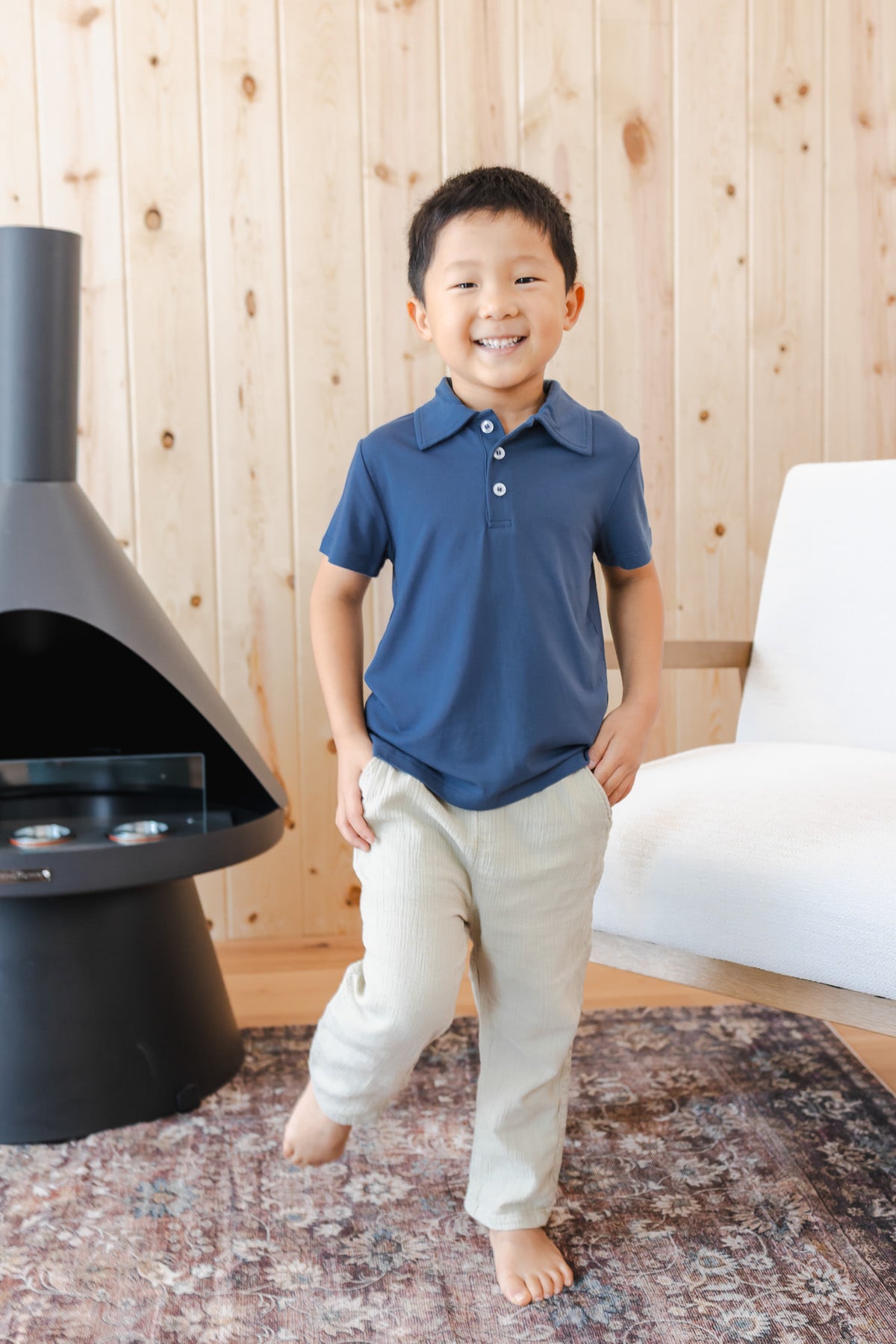 Toddler posing in Toddler Short Sleeve Polo in Oxford over white pants