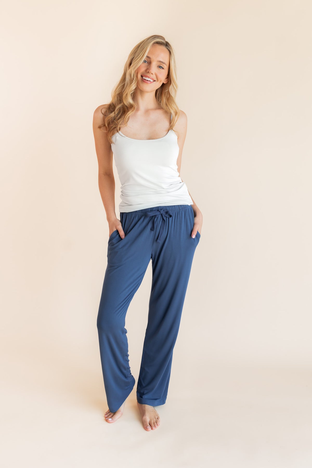 Model posing in Women's Lounge Pants in Oxford under a white camisole on a beige background