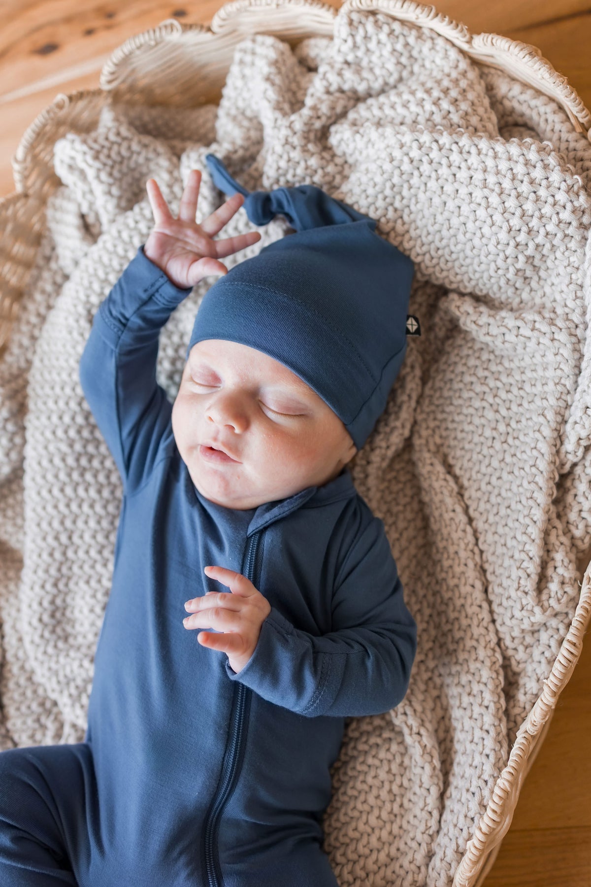 Baby wearing Knotted Cap in Oxford with zippered footie in Oxford