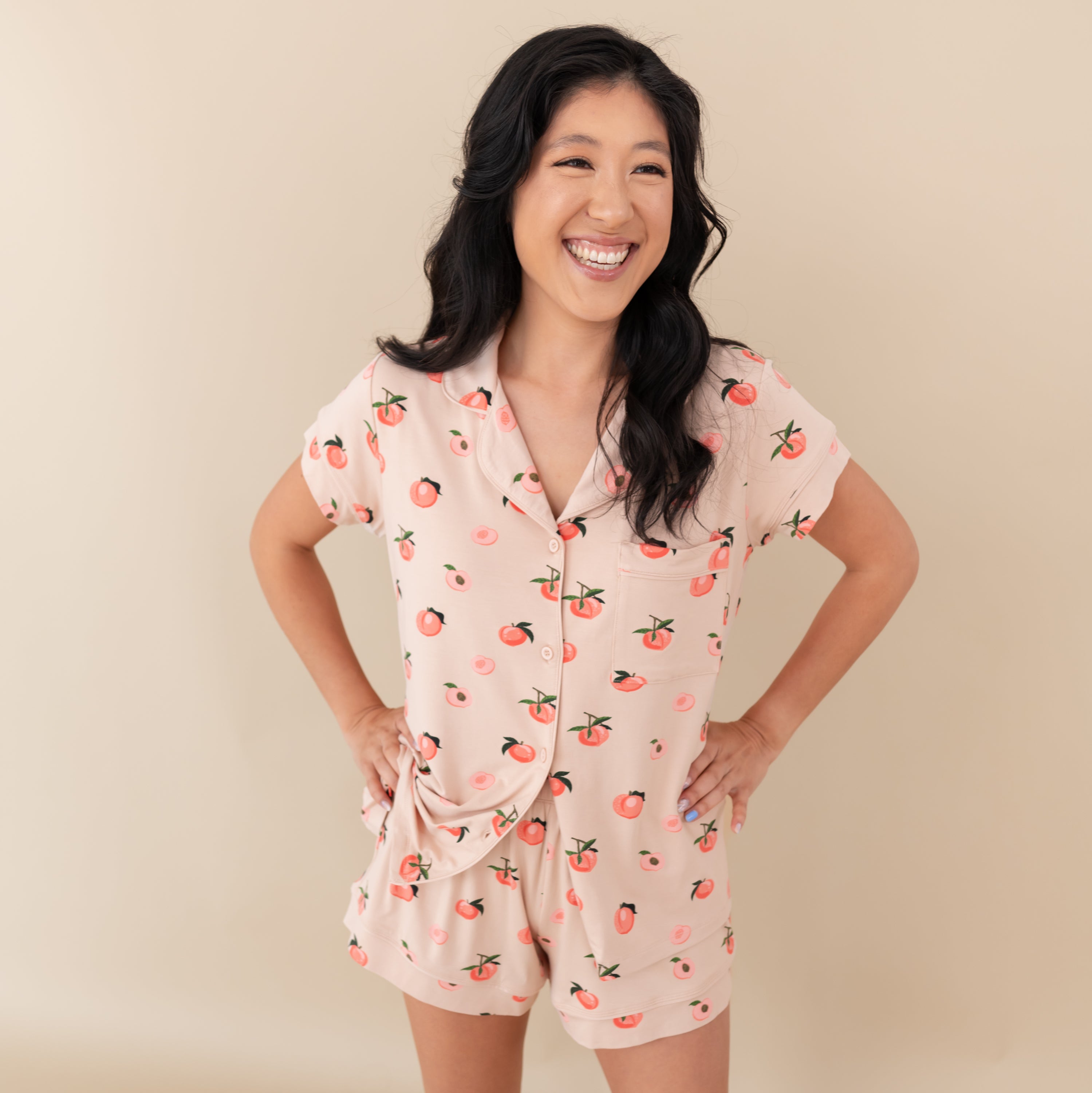 Woman modeling Women’s Short Sleeve Pajama Set in Peach with hand on hips
