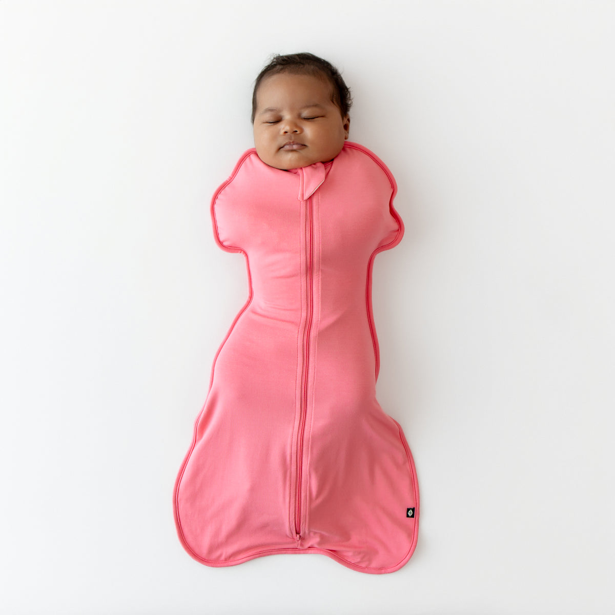 Baby sleeping in Swaddle Bag in Guava 0.5