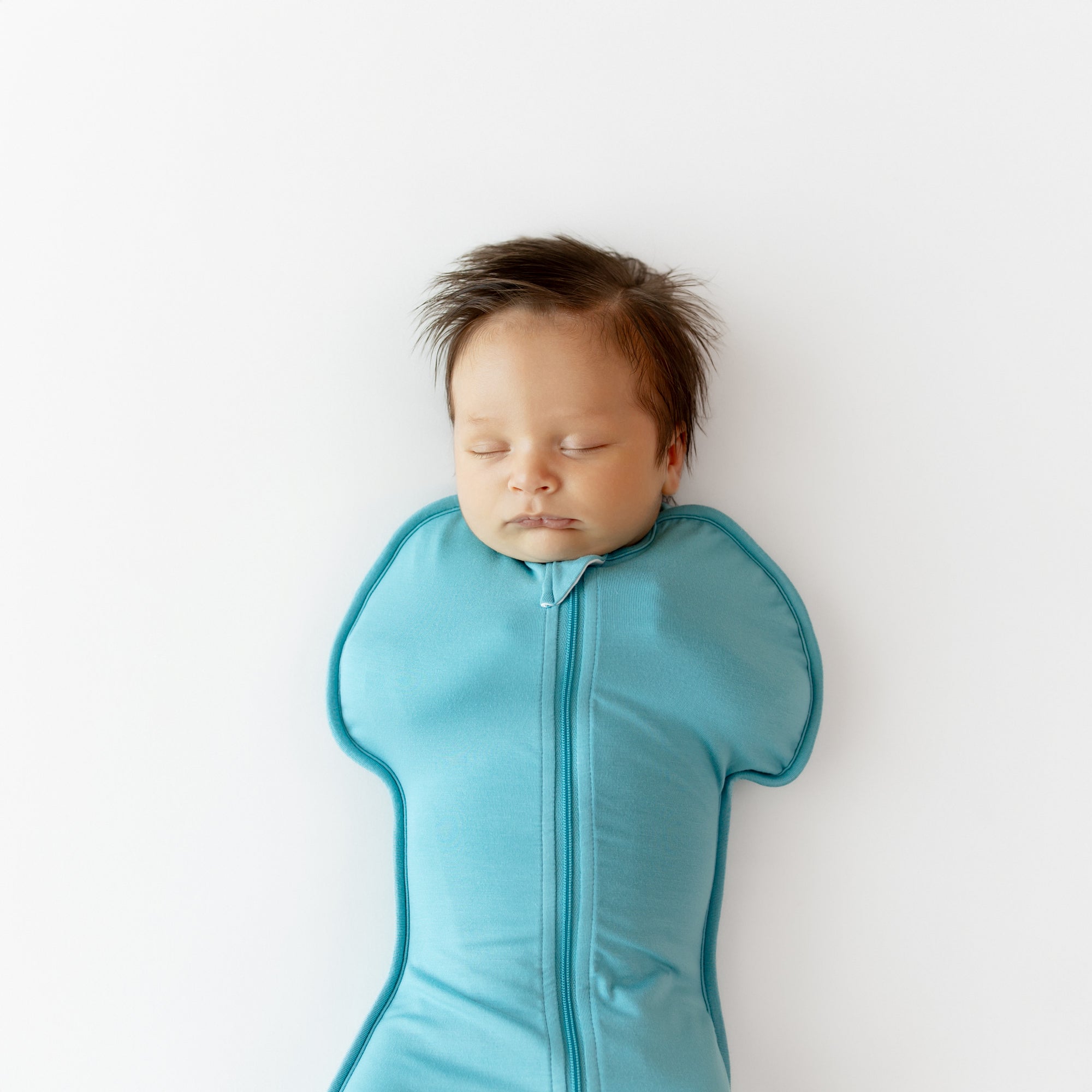 Close up of baby asleep in Swaddle Bag in Makai 0.5