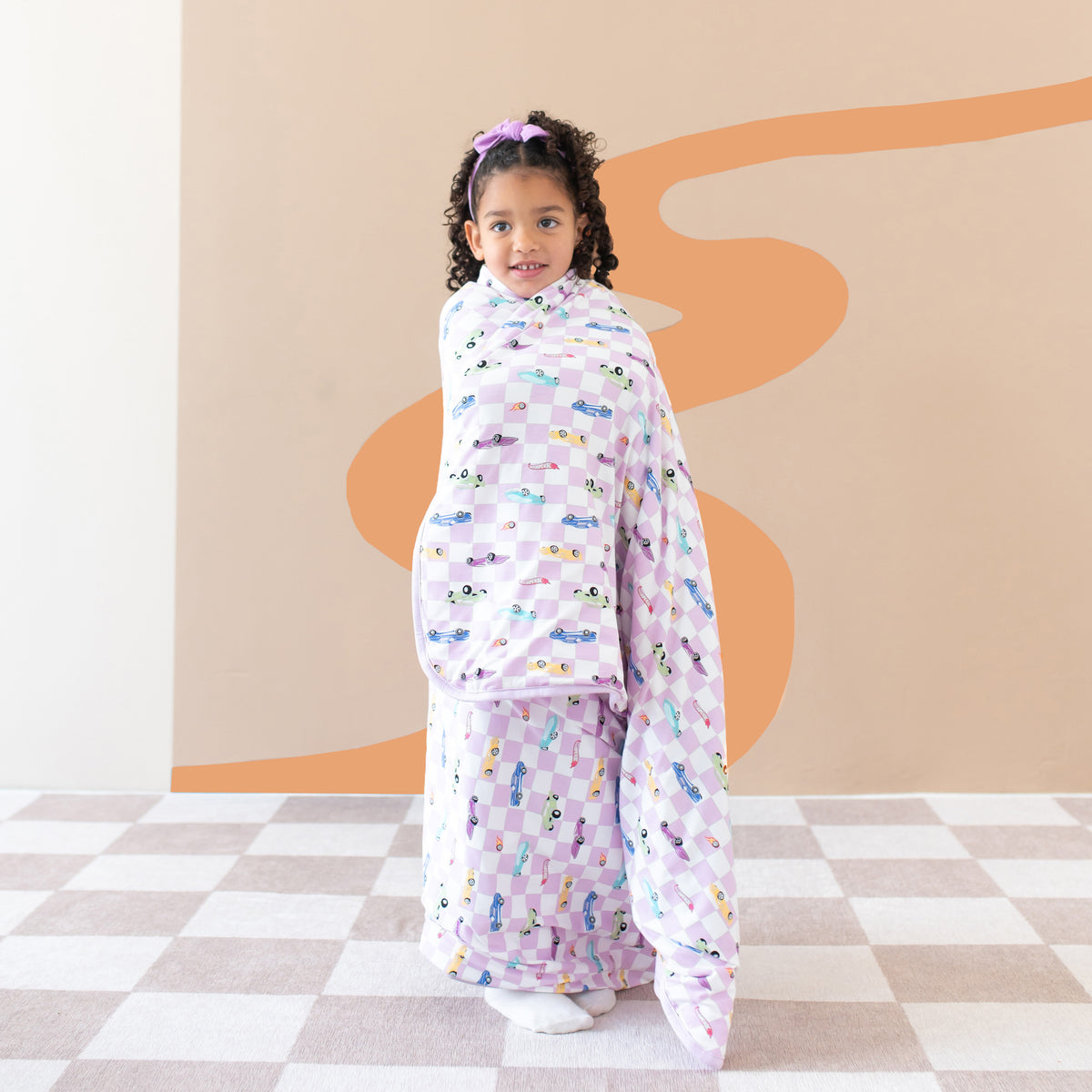 Girl wrapped in Hot Wheels Toddler Blanket in Sparkles and Speed 1.0 TOG
