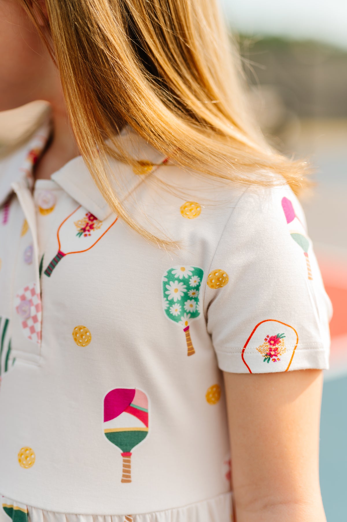 Close up of Girl wearing Polo Dress in Pickleball print