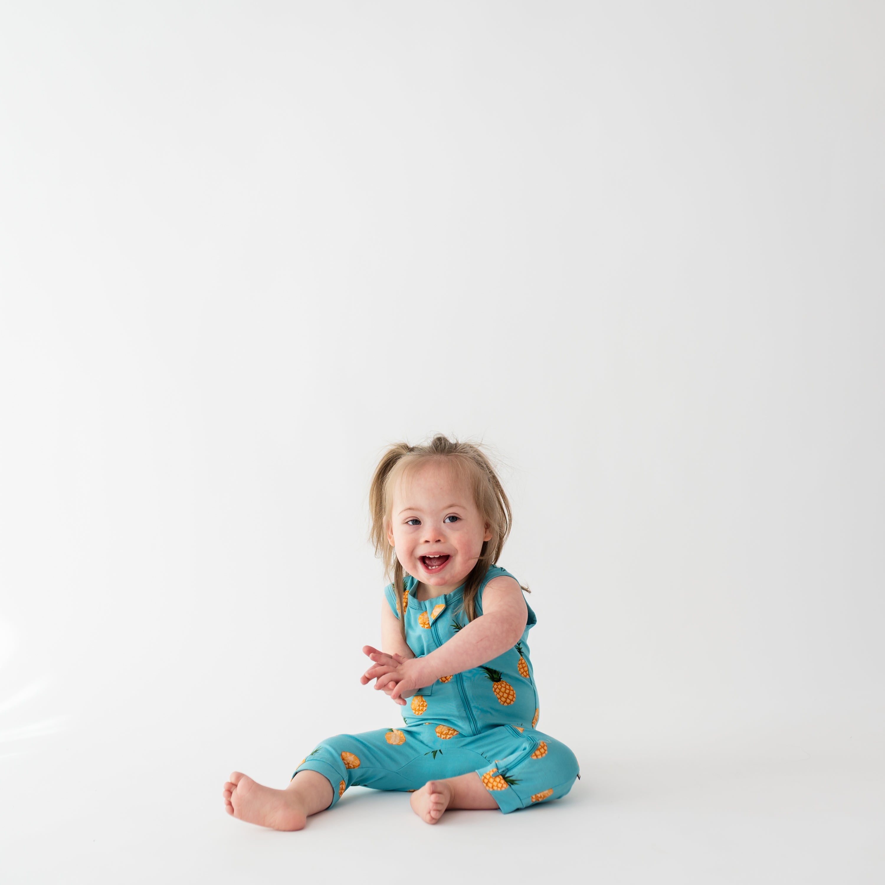 Toddler wearing breathable bamboo Kyte Baby Sleeveless Zippered Romper in Pineapple