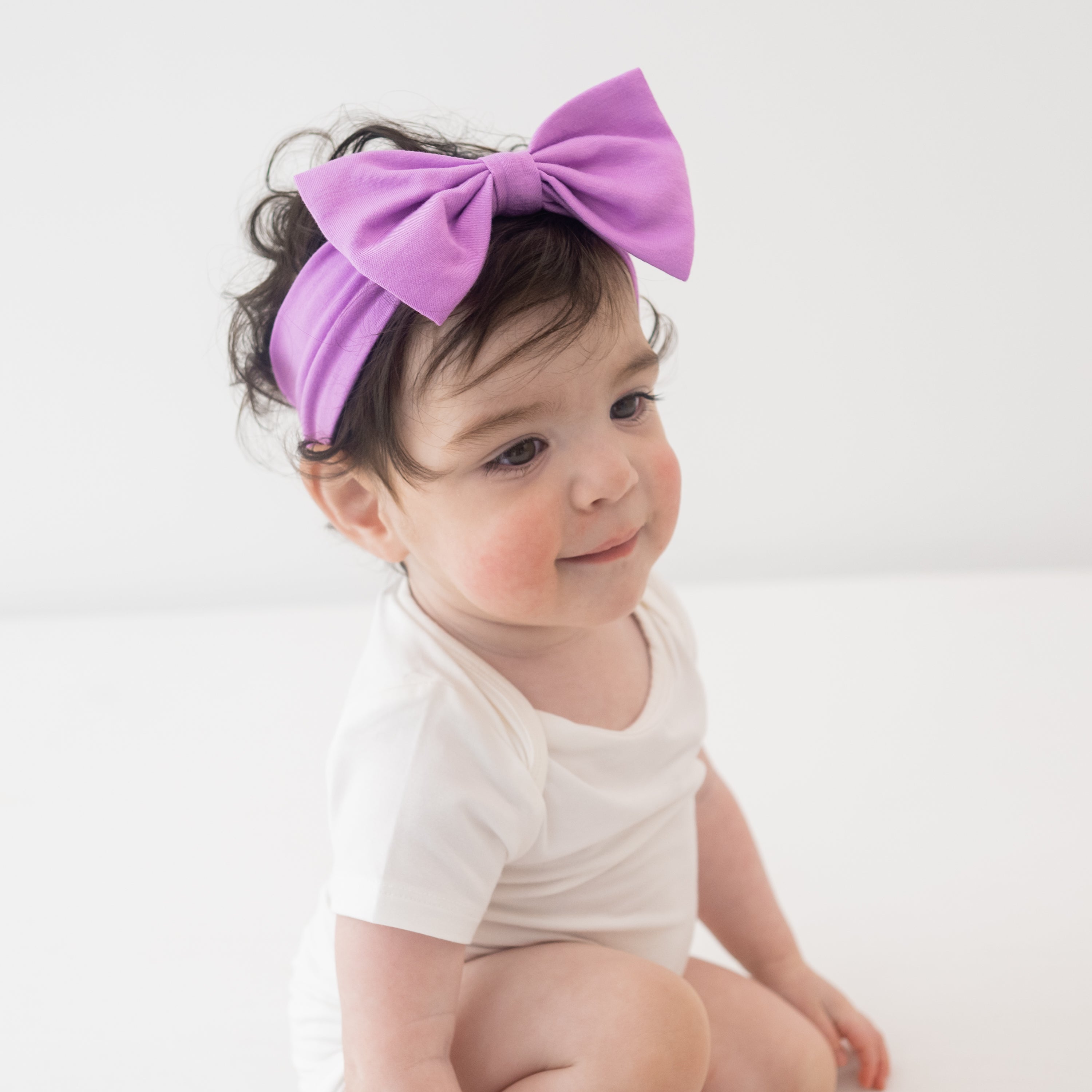 Baby wearing Bow Headband in Poi