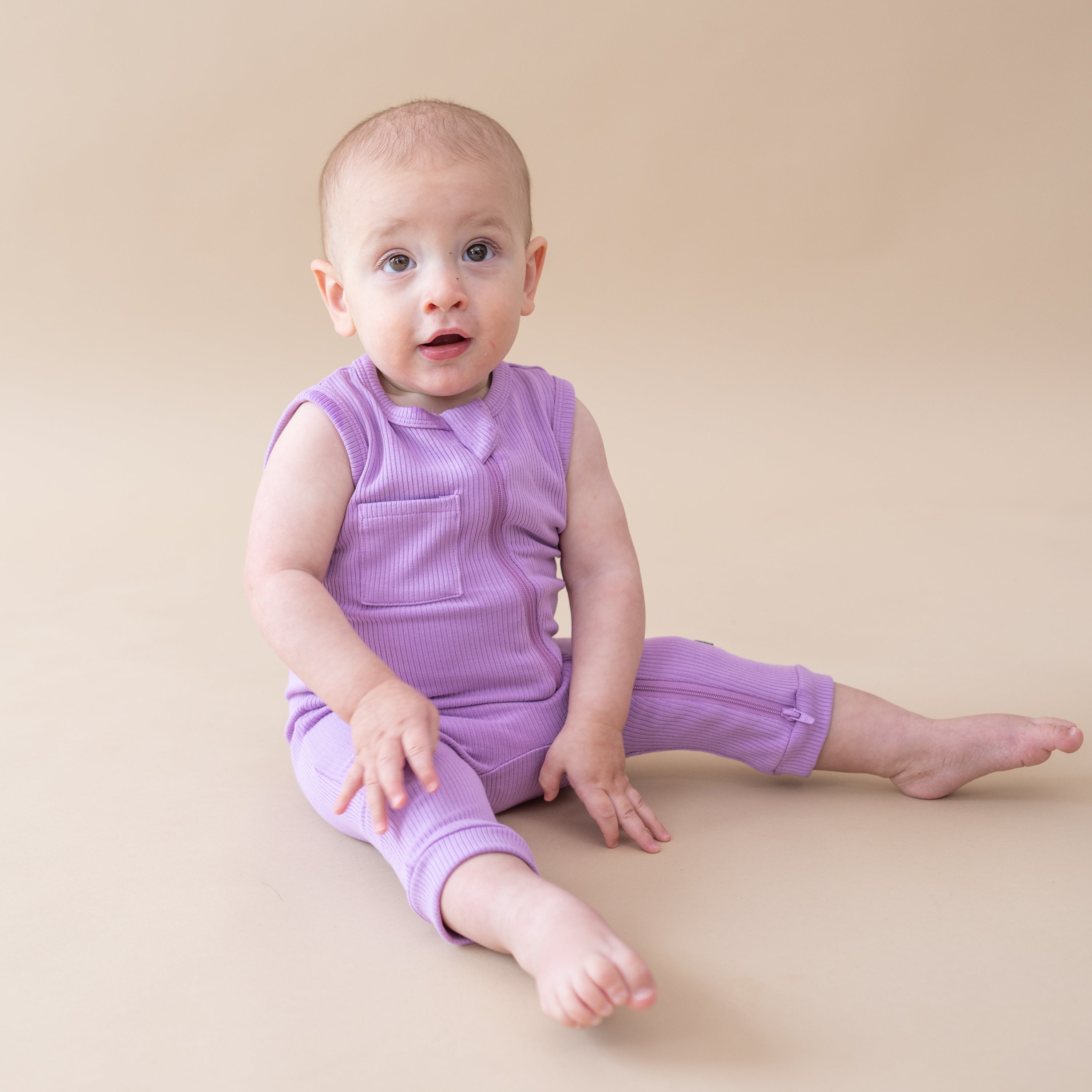 Infant wearing Ribbed Zippered Sleeveless Romper in Poi purple