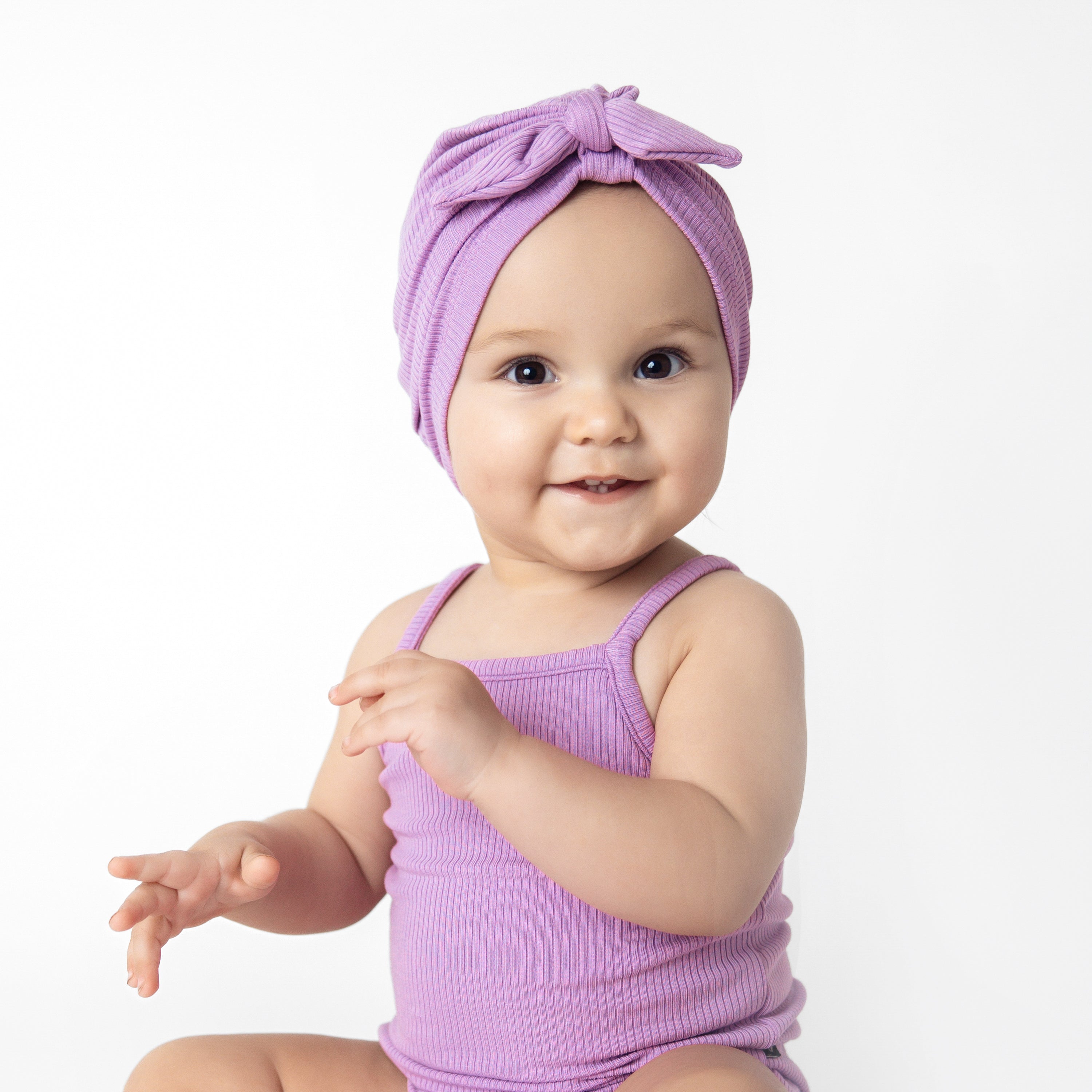 Baby wearing Tie Front Ribbed Headwrap in Poi