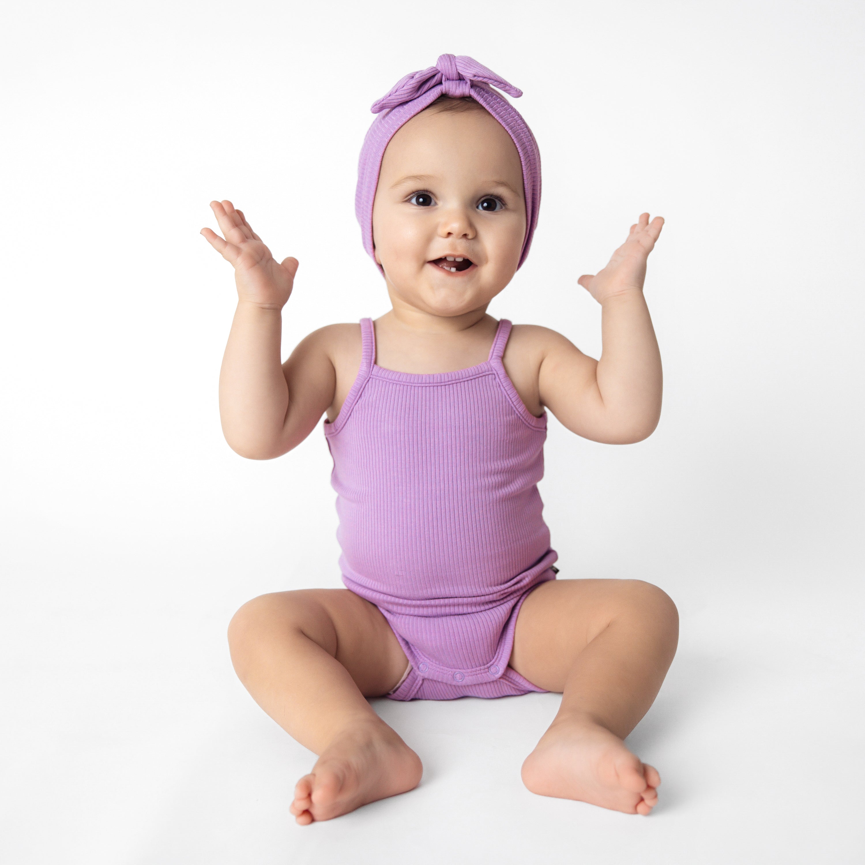 Baby wearing Ribbed Spaghetti Strap Bodysuit in Poi Purple