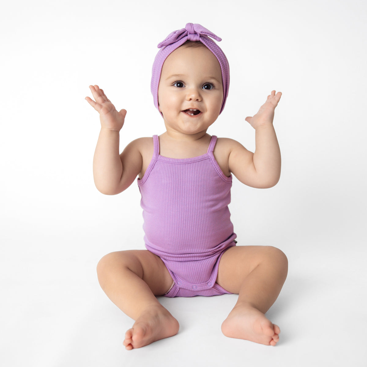 Baby wearing Ribbed Spaghetti Strap Bodysuit in Poi Purple