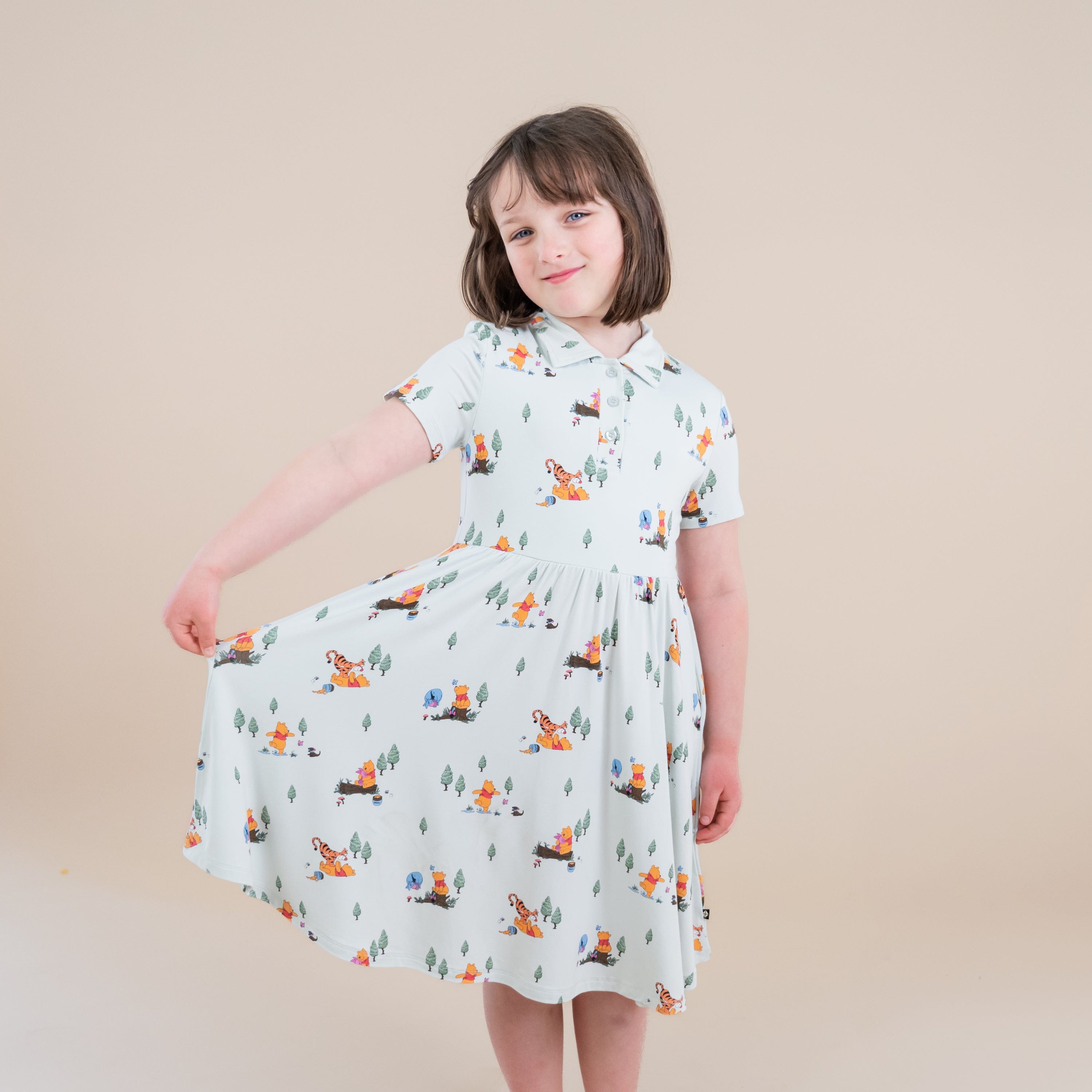 Young girl modeling the Polo Dress in Winnie the Pooh Hundred Acre Wood