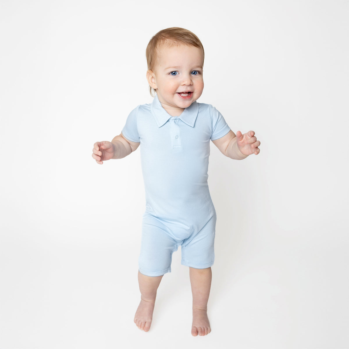 Young toddler walking wearing the Polo Shortall in Breeze