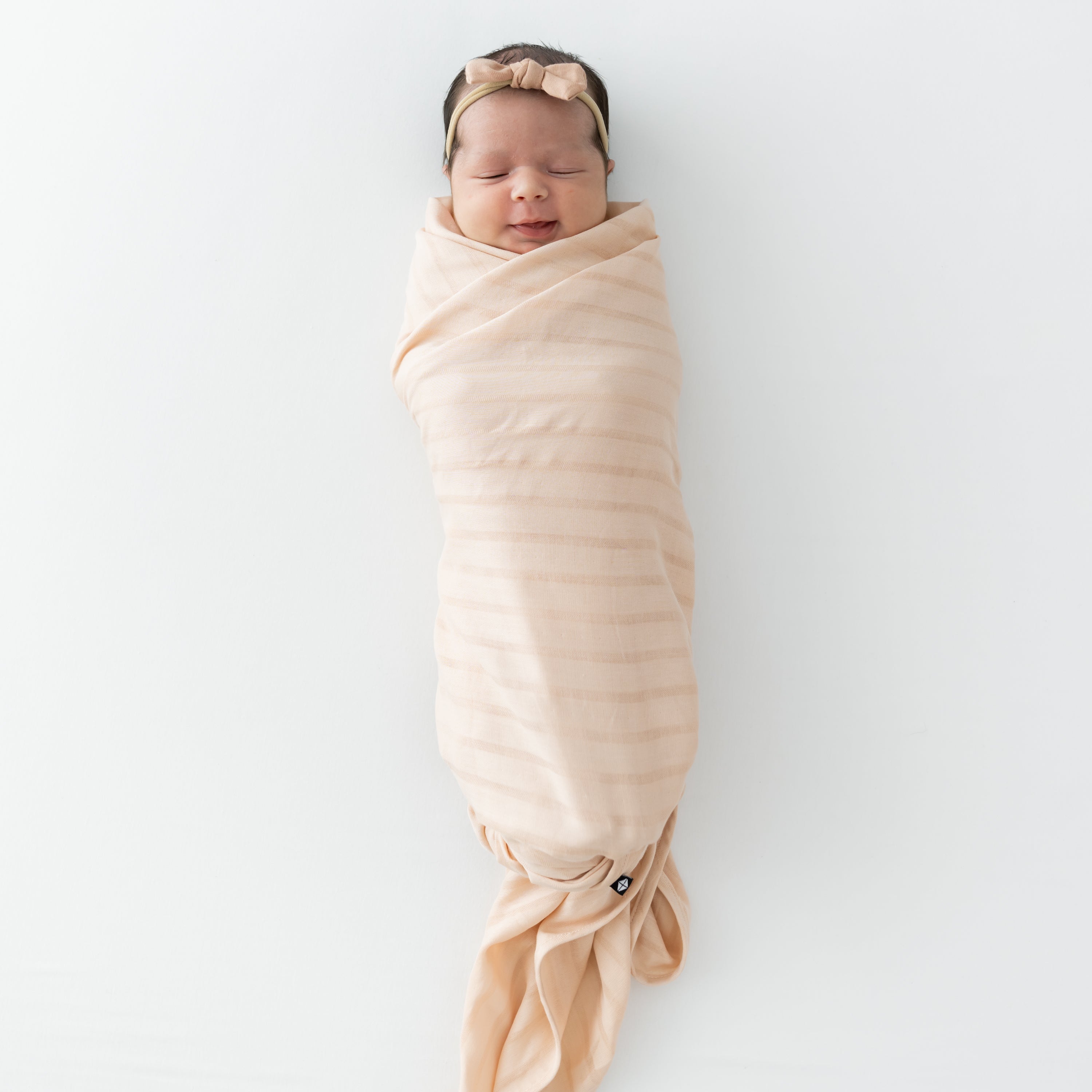 Baby wrapped in Bamboo Muslin Swaddle Blanket in Porcelain