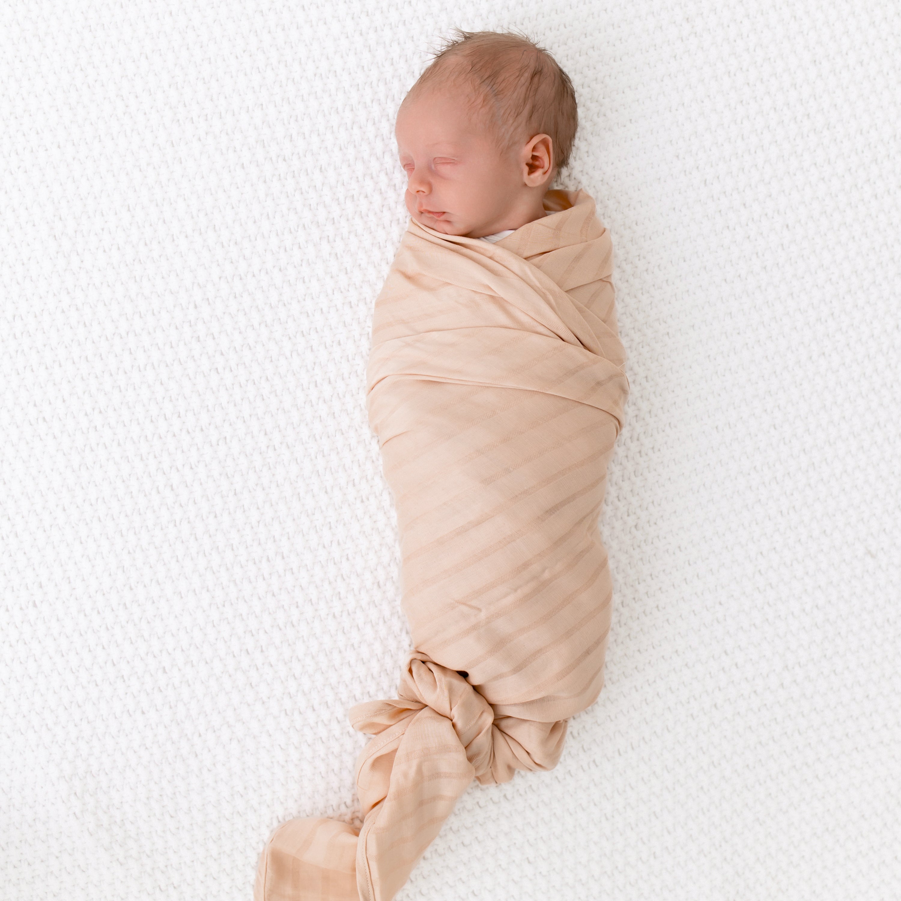 Newborn Swaddled in Bamboo Muslin Swaddler Blanket in Porcelain with Woven Striped Detail