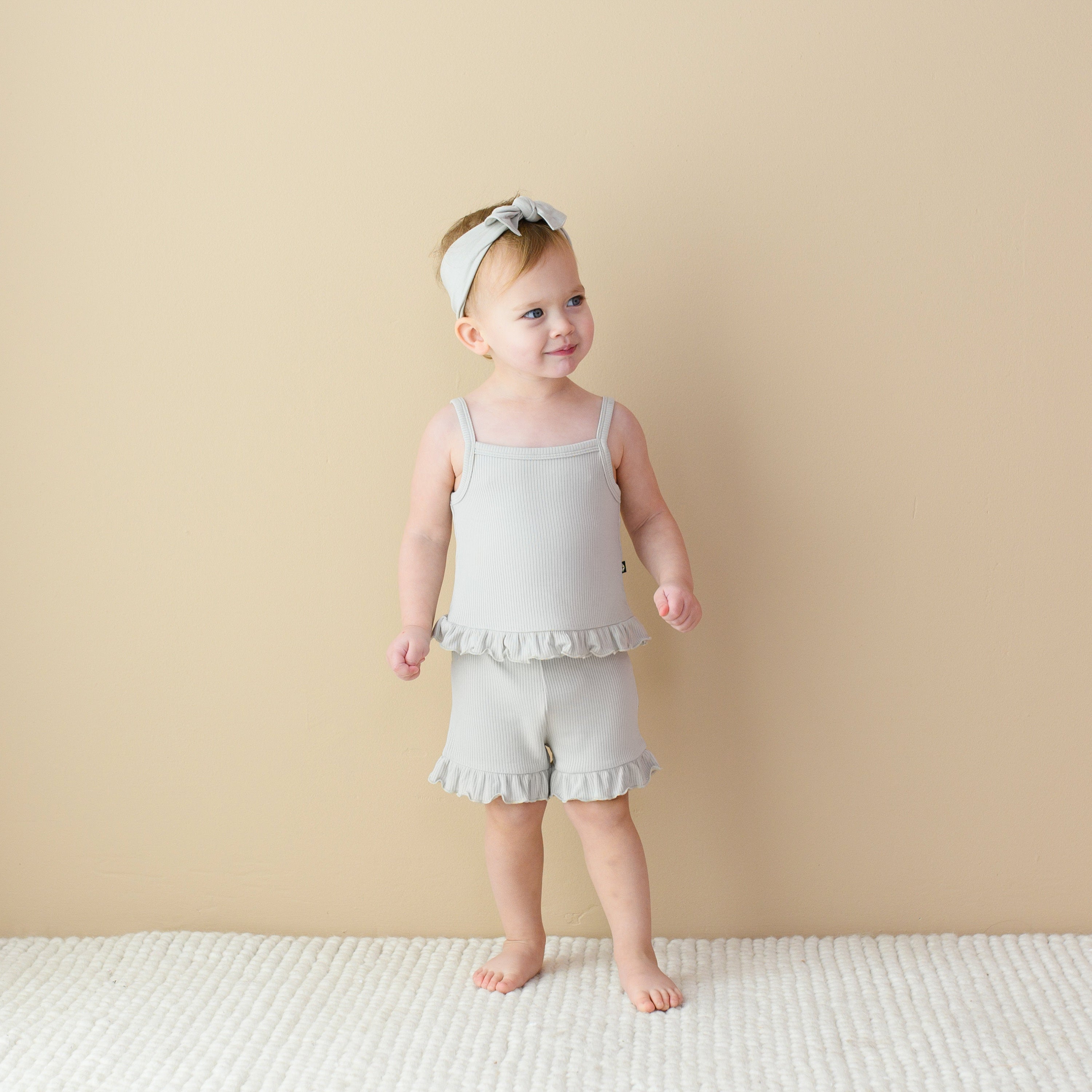 Toddler wearing Bamboo Ribbed Ruffle Tank and Shorts Set in Oat
