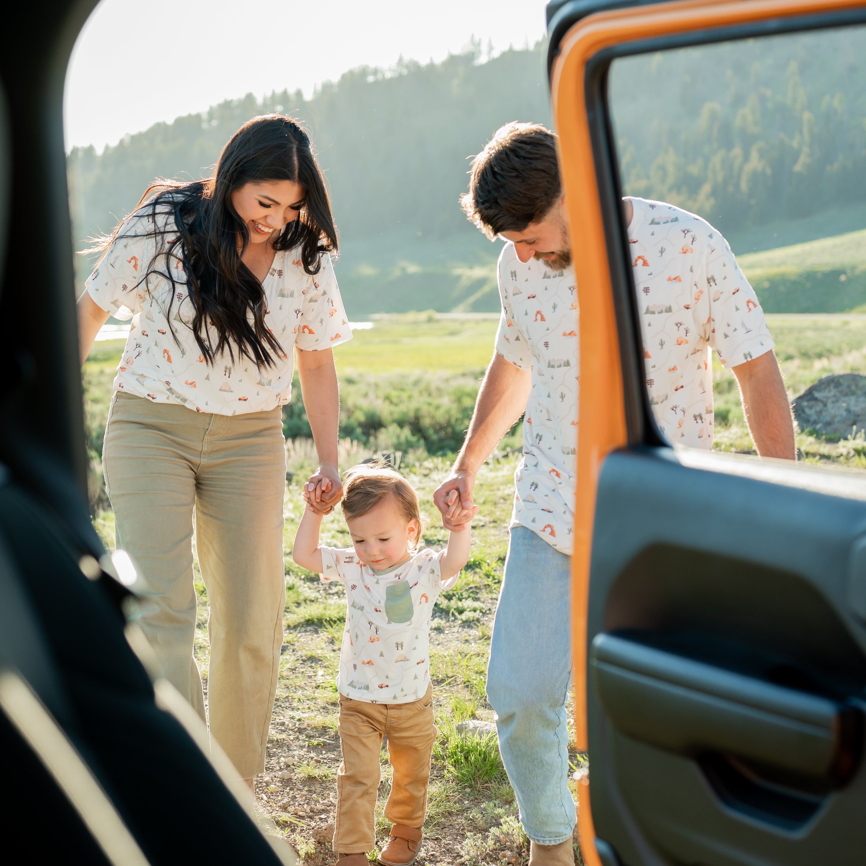 Family in matching Road Trip t-shirts holding hands