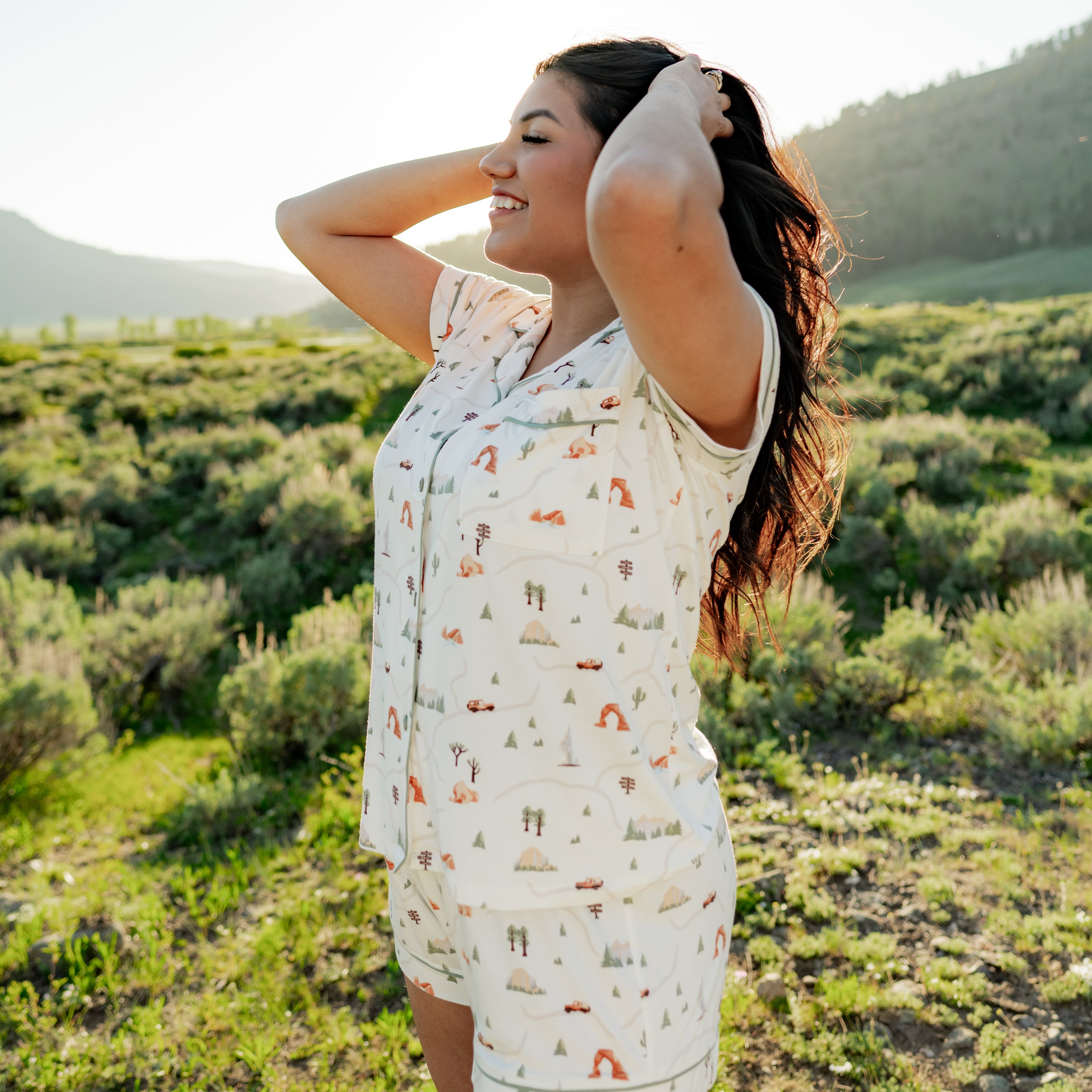 Woman modeling Women's Short Sleeve Pajama Set in Road Trip in Yellowstone National Park holding hair up