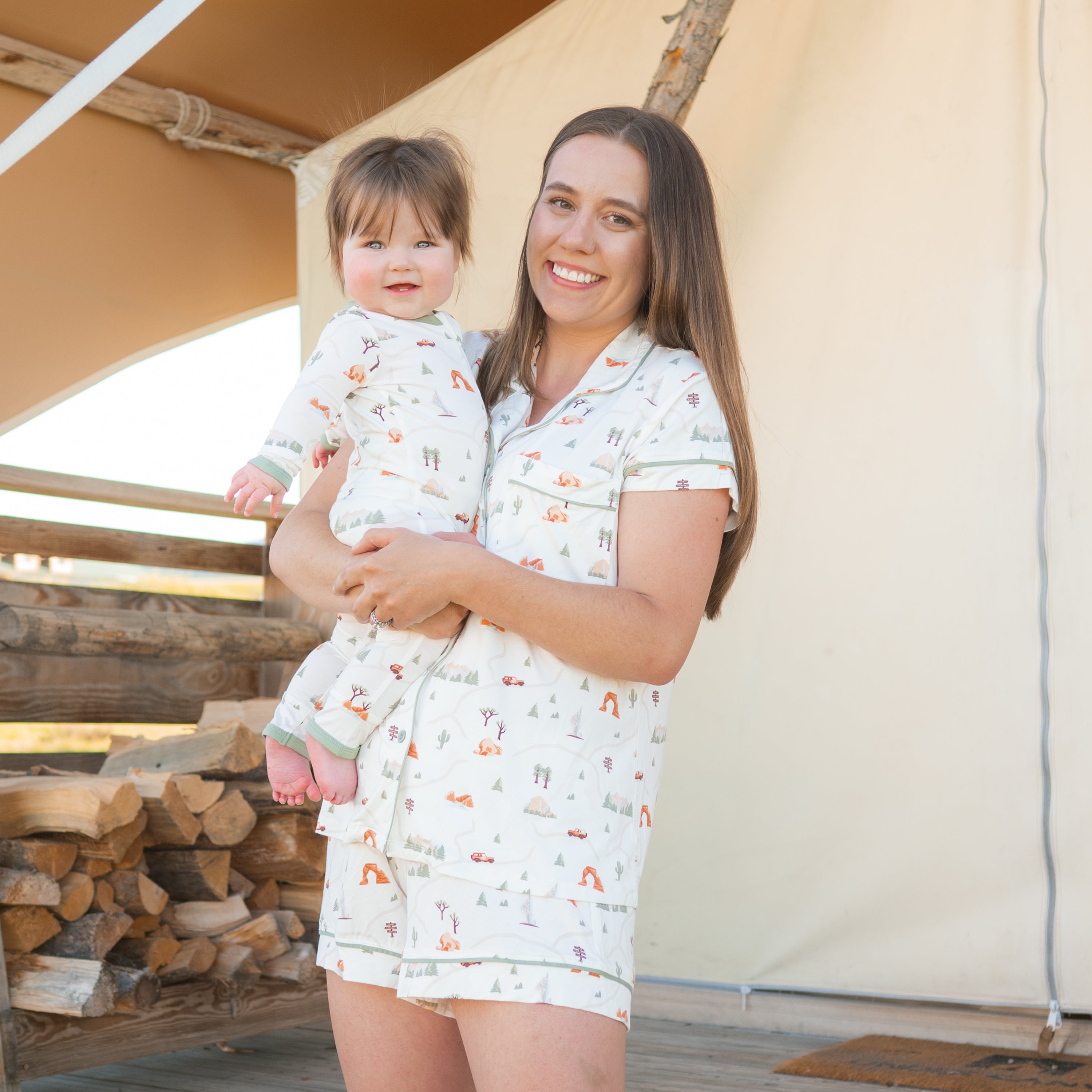 Mom in Road Trip Short Sleeve Pajamas holding toddler in Zippered Romper in Road Trip