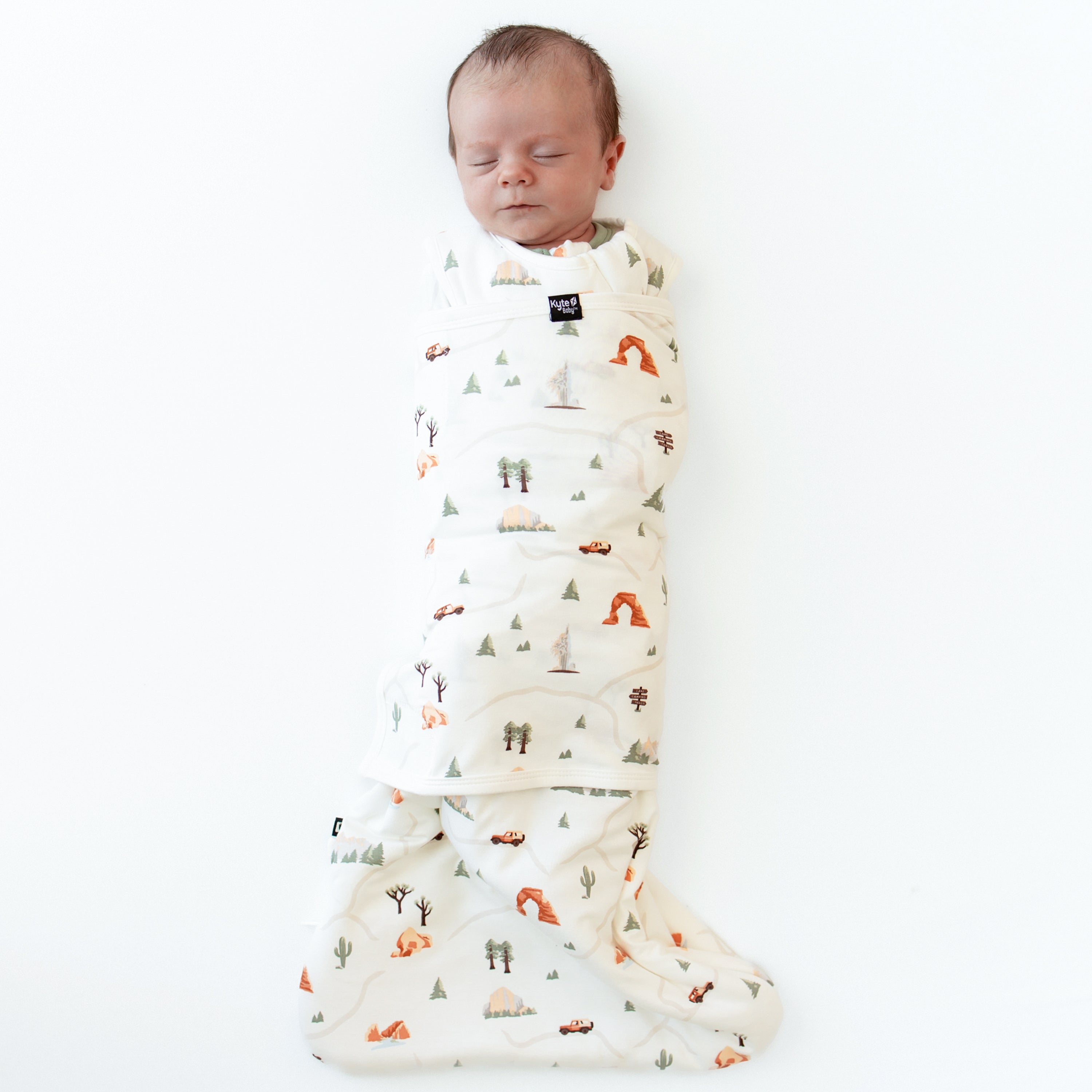 Sleeping baby swaddled in the Sleep Bag Swaddler in Road Trip 1.0