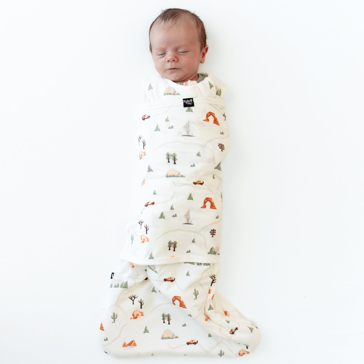 Sleeping baby swaddled in the Sleep Bag Swaddler in Road Trip 1.0