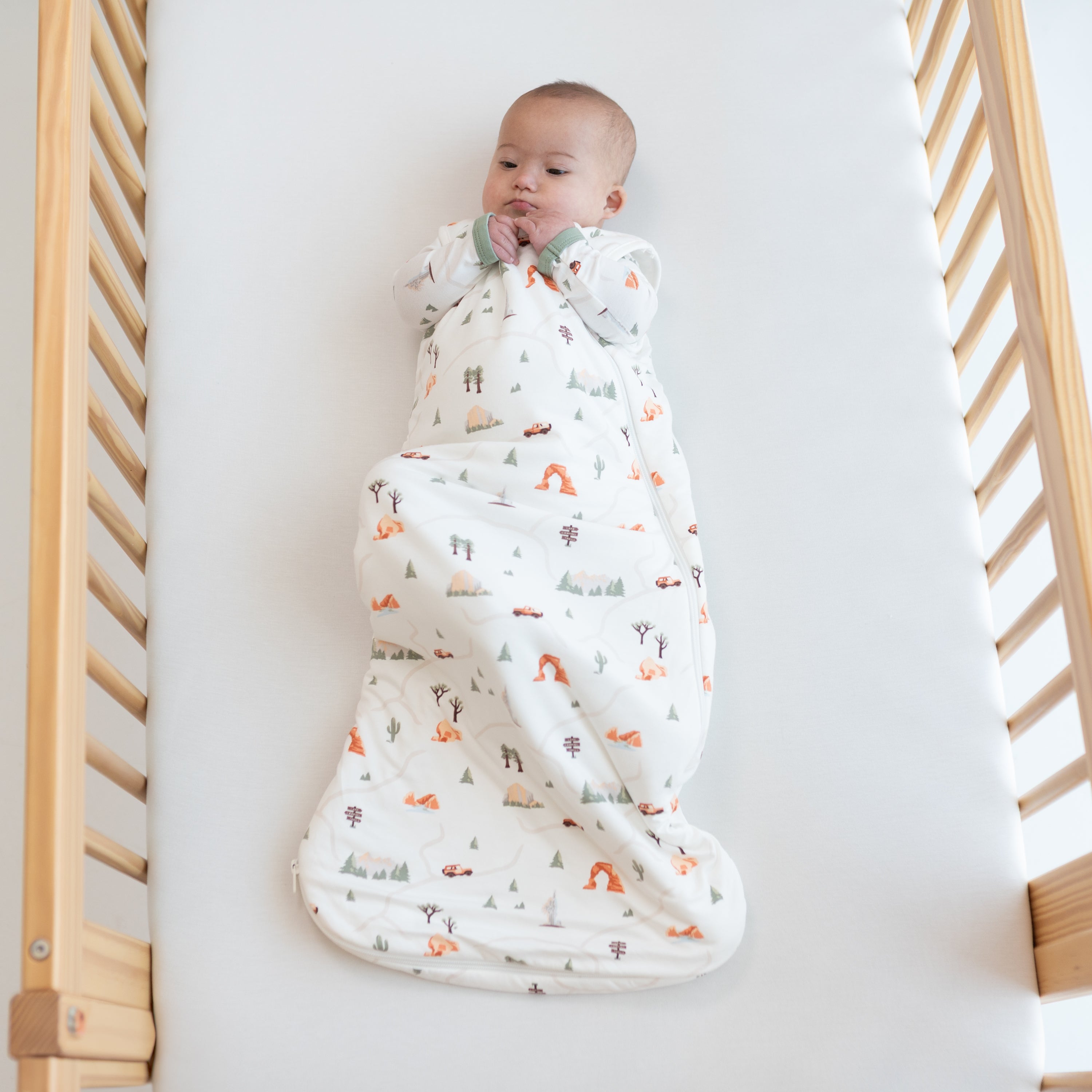 Infant wearing TOG 1.0 Bamboo Sleep Bag in Roadtrip
