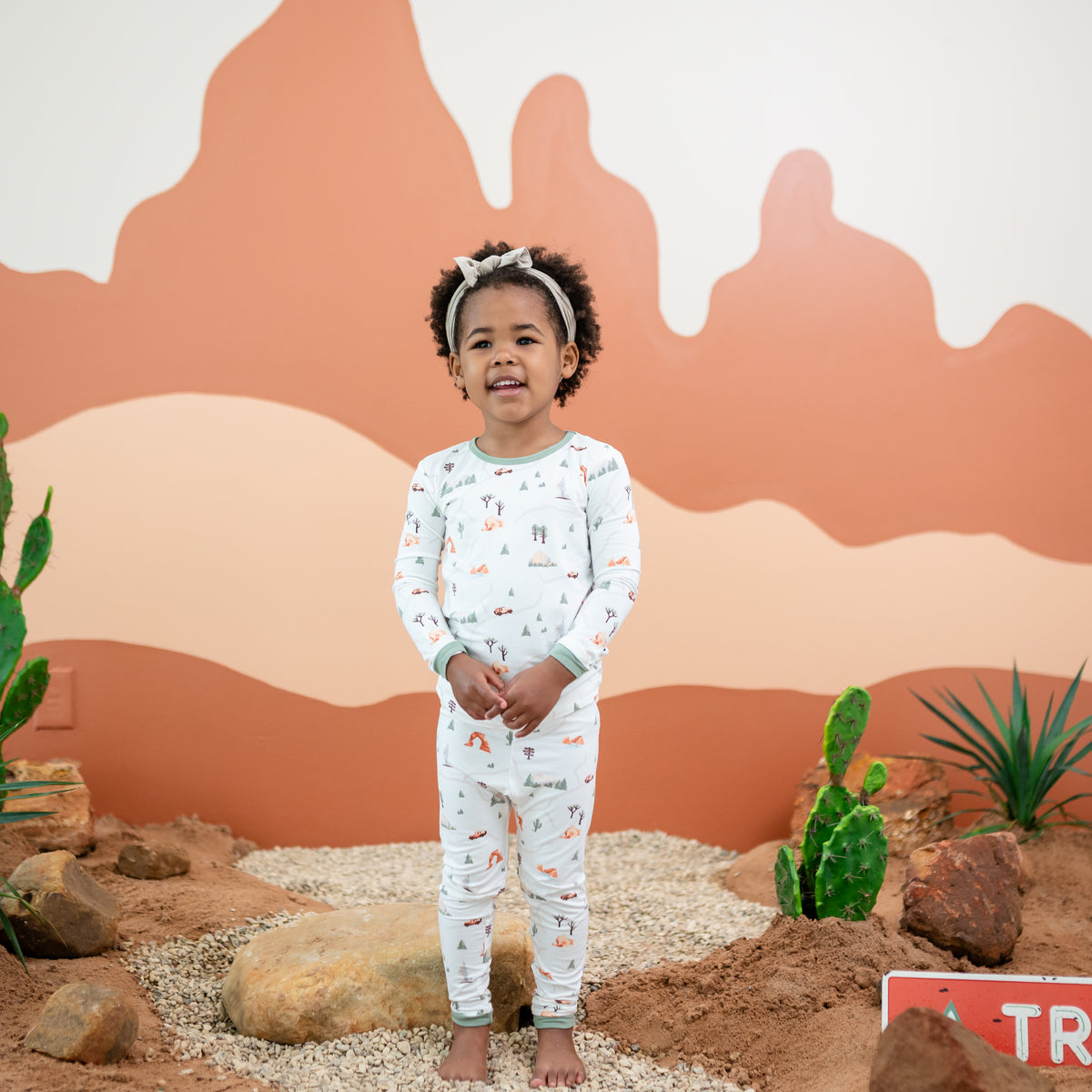 Girl model wearing the Long Sleeve Pajamas in Road Trip standing in a desert back drop