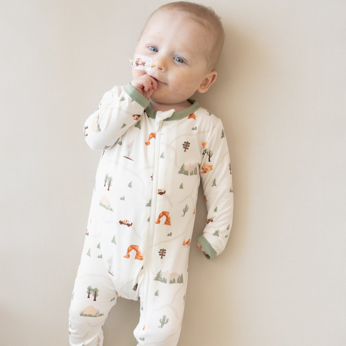 Baby wearing Kyte Baby Road Trip Zippered Romper