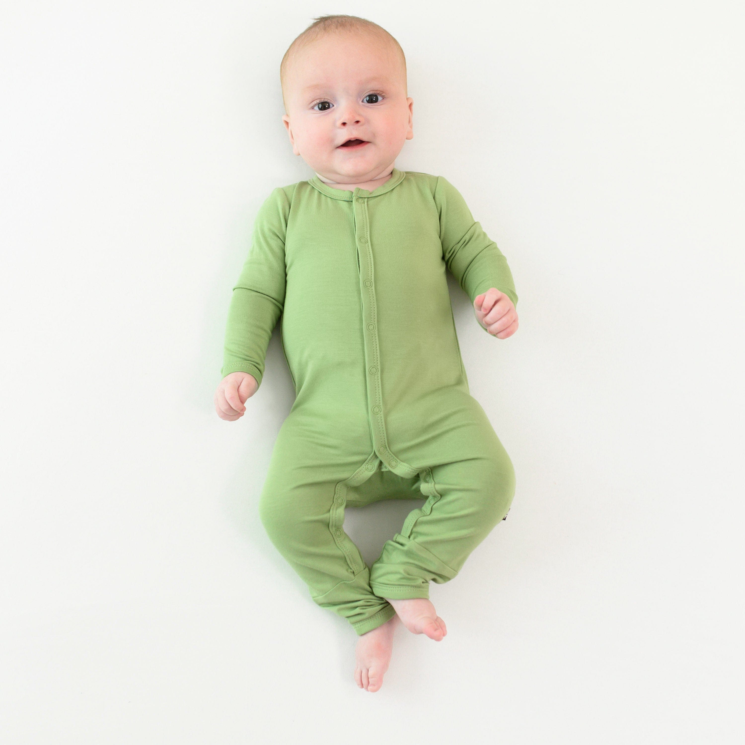 baby wearing snap romper in honu