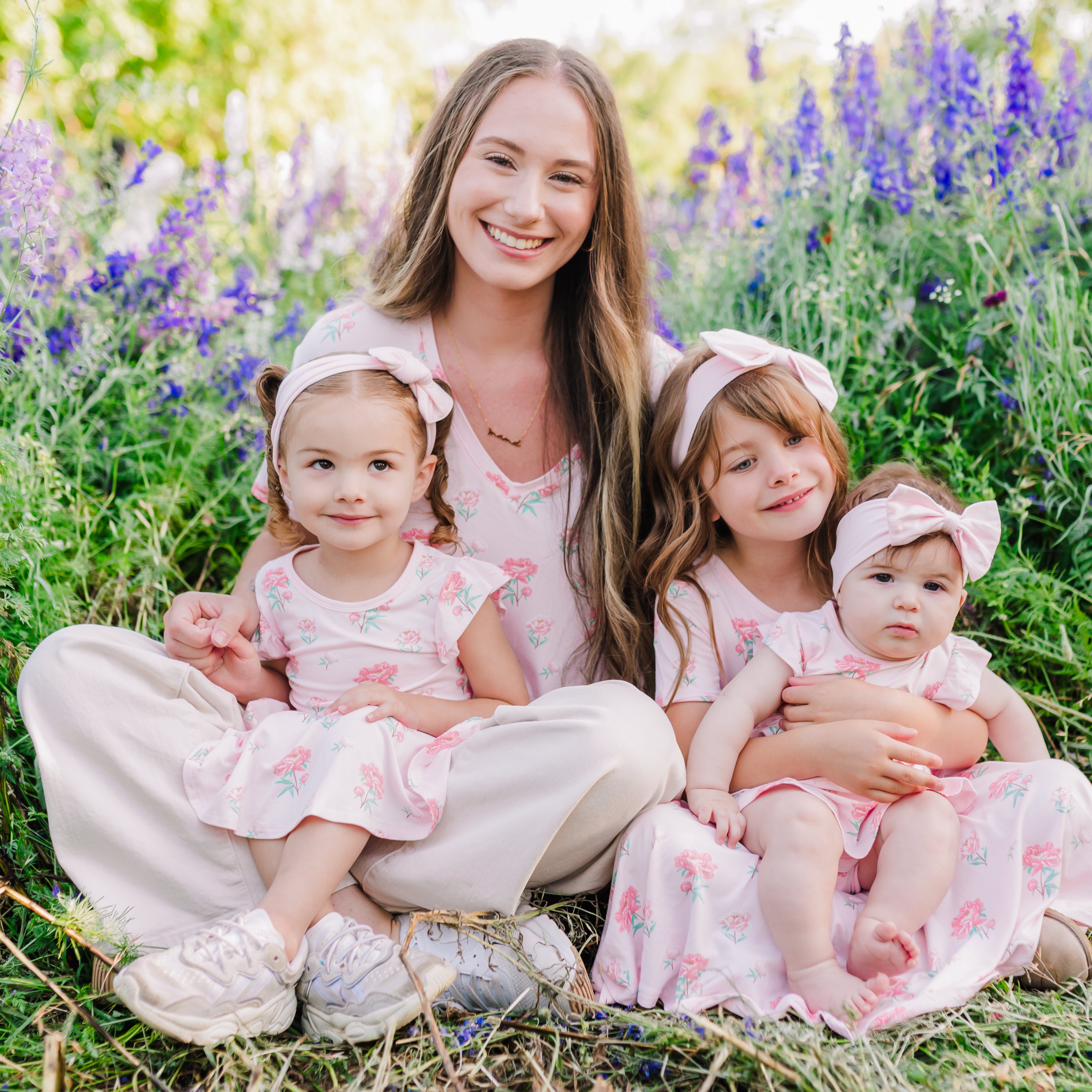 Woman modeling Women's Relaxed Fit V-Neck in Sakura Peony surrounded by her 3 kids in matching Sakura Peony outfits