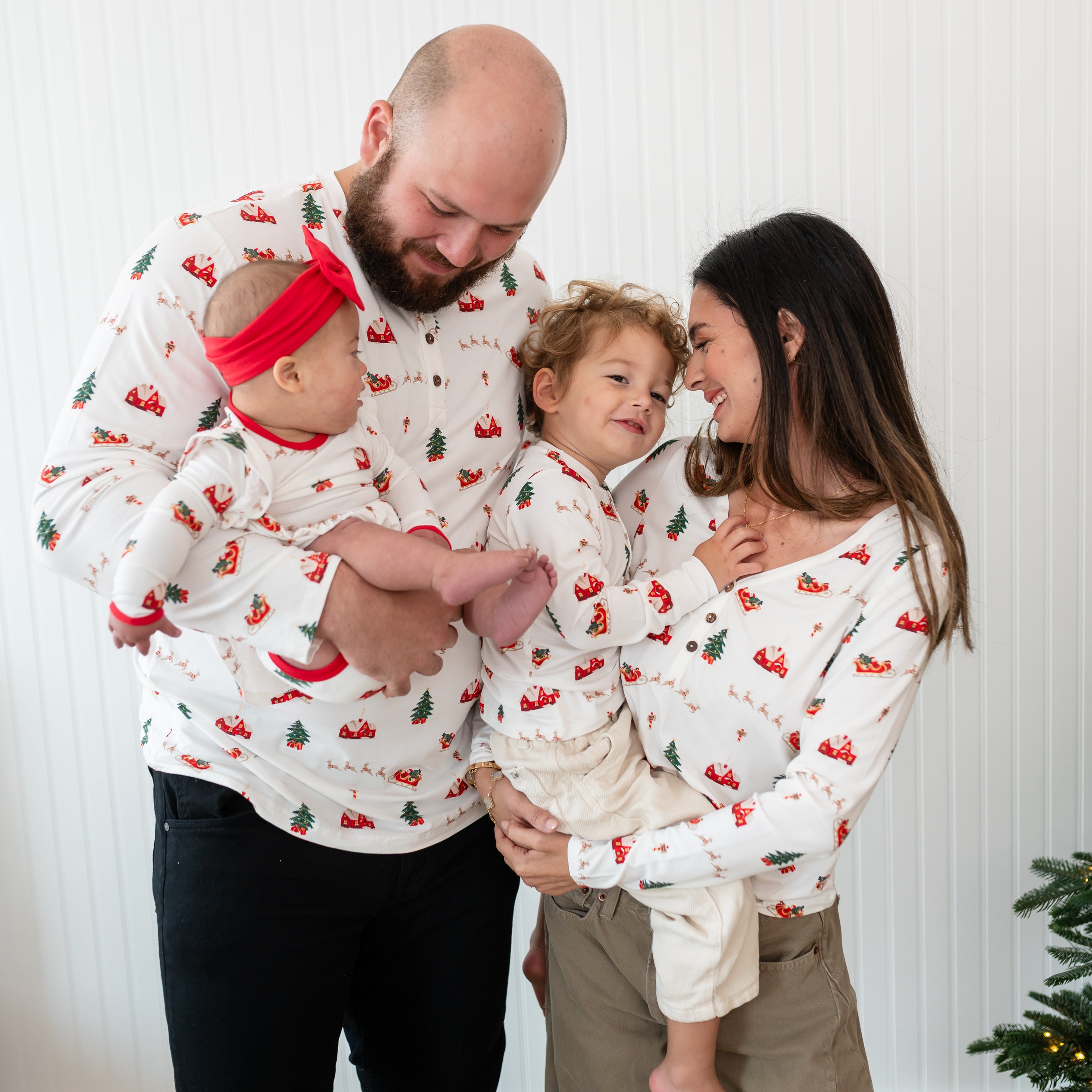 Family of four matching in Santa Sleigh