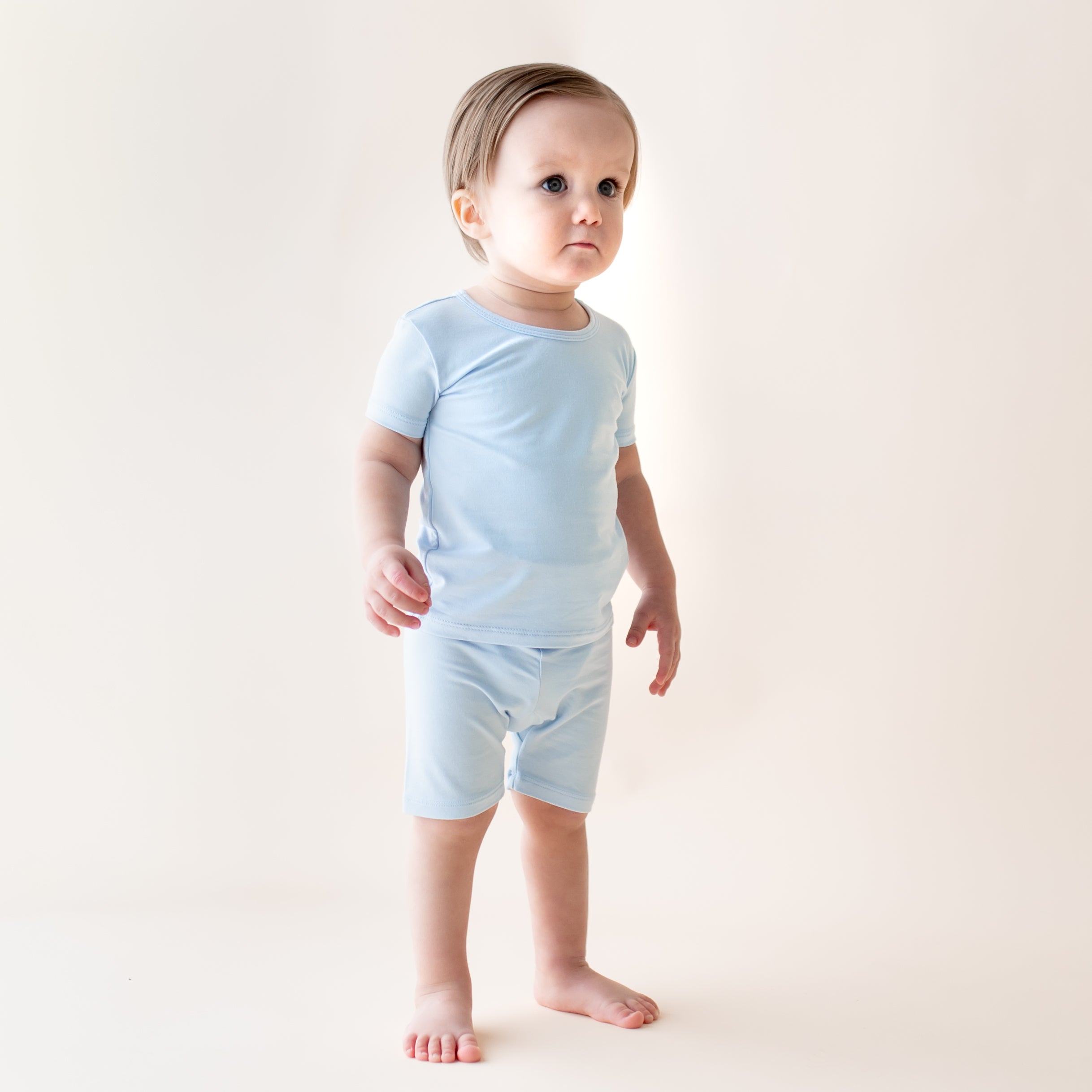 Young toddler boy in a light blue short sleeve pajama set