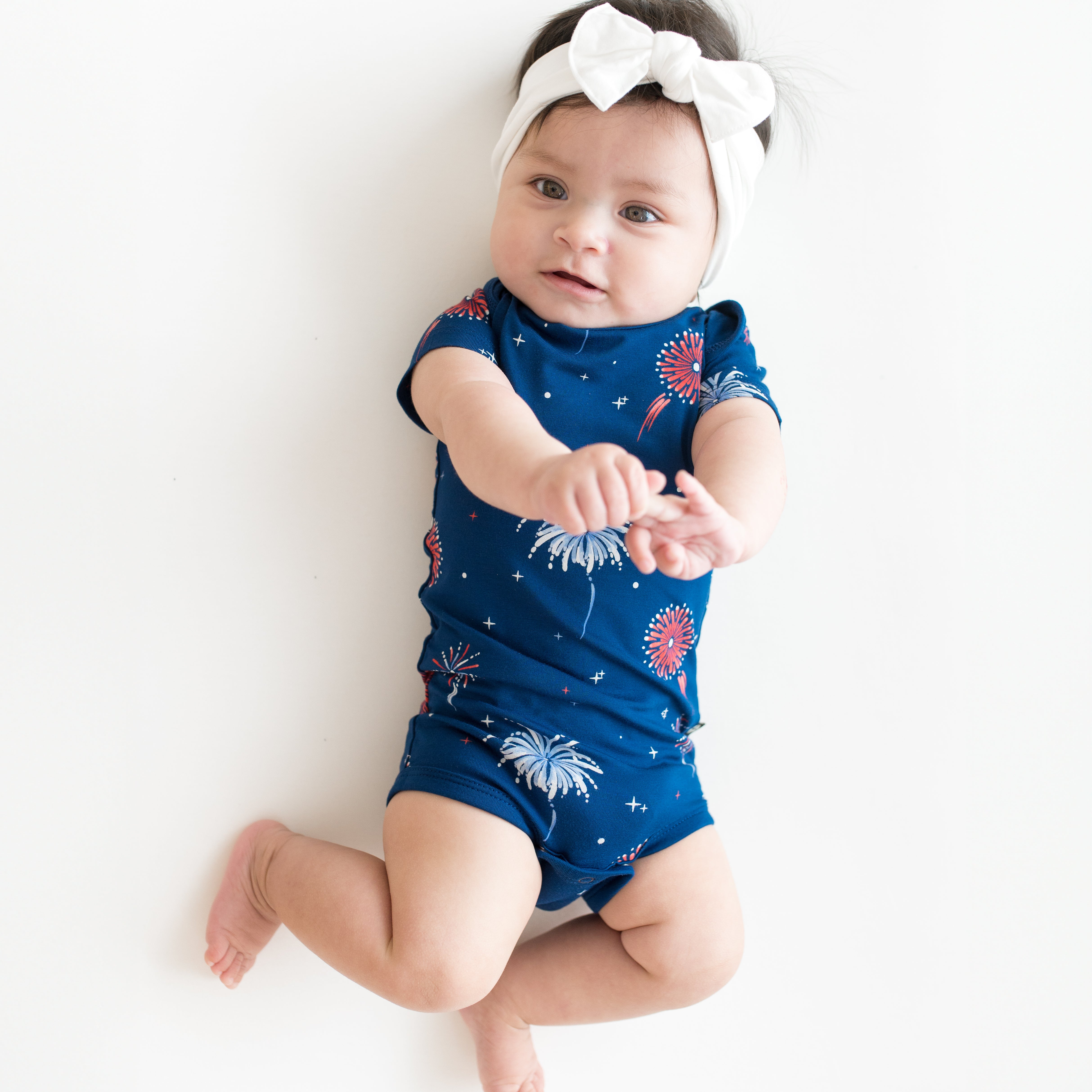 Baby modeling Bodysuit in Celebration and Cloud Bow