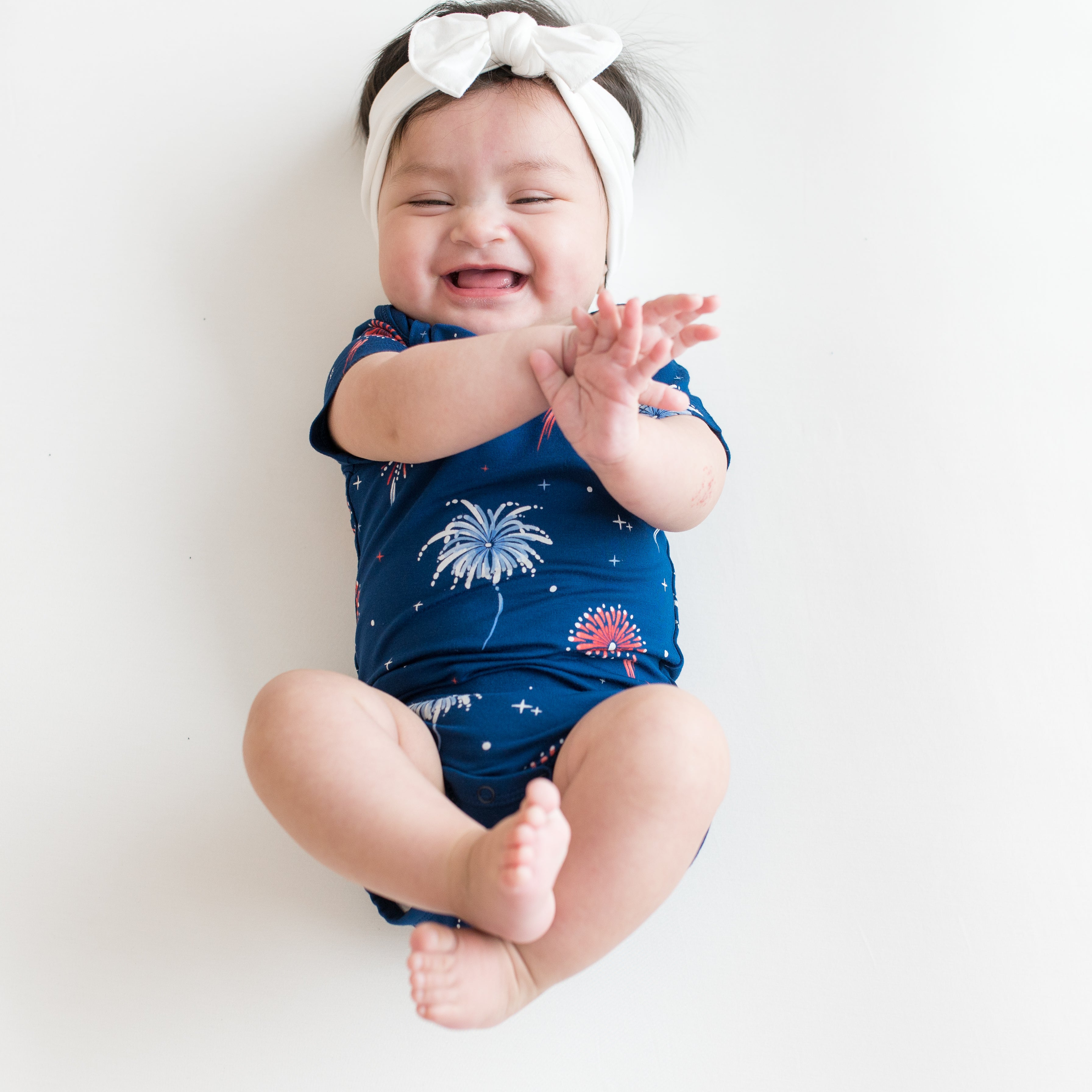 Baby smiling wearing Bodysuit in Celebration and Cloud Bow