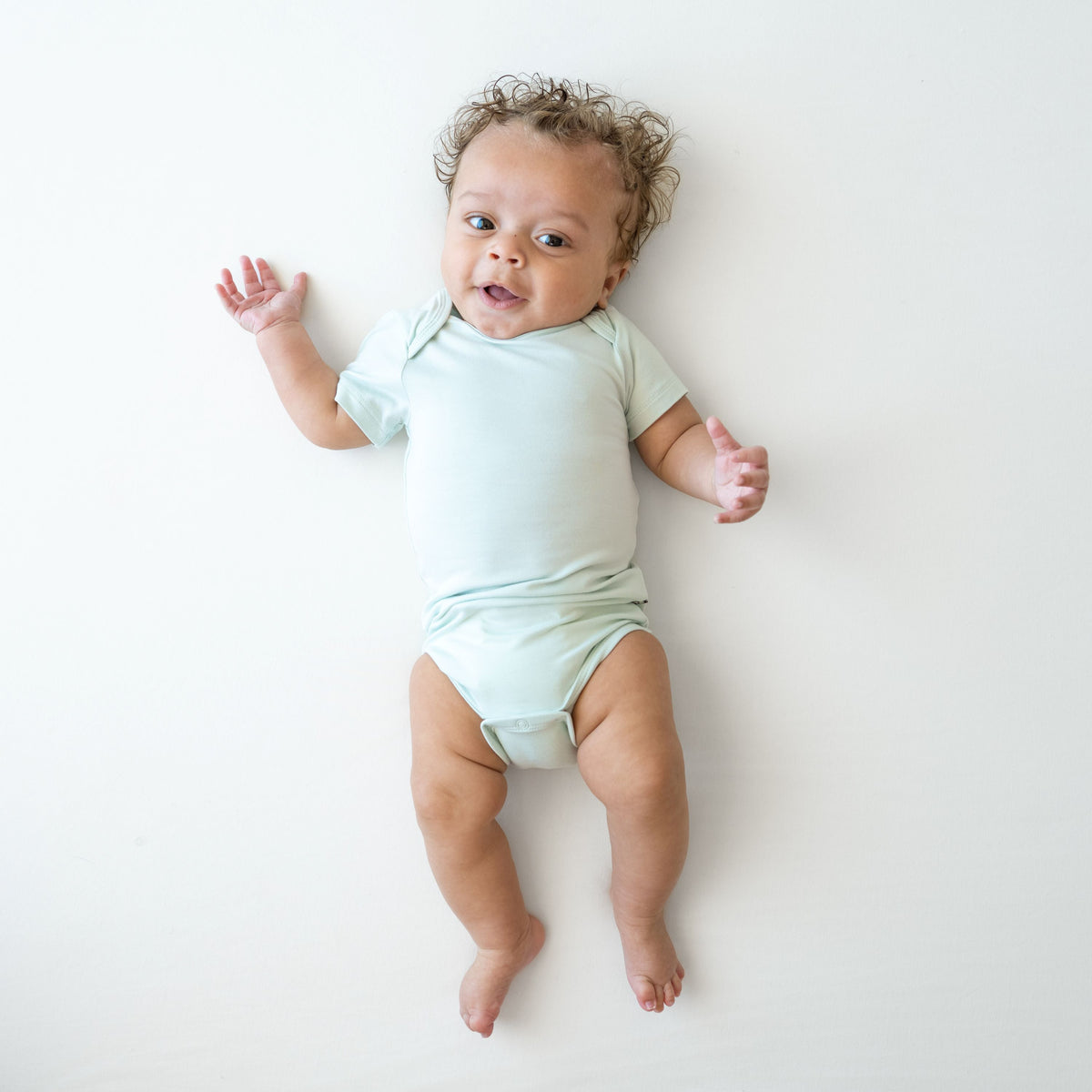 Smiling infant wearing the Bodysuit in Dew