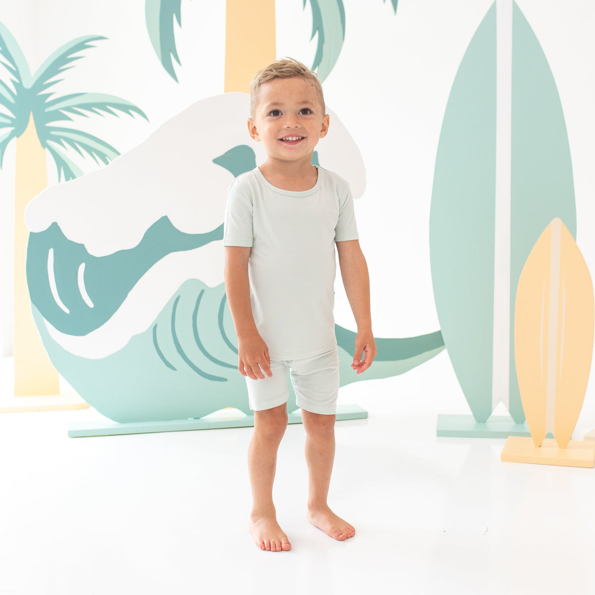 Young boy model wearing the Short Sleeve Pajamas in Dew