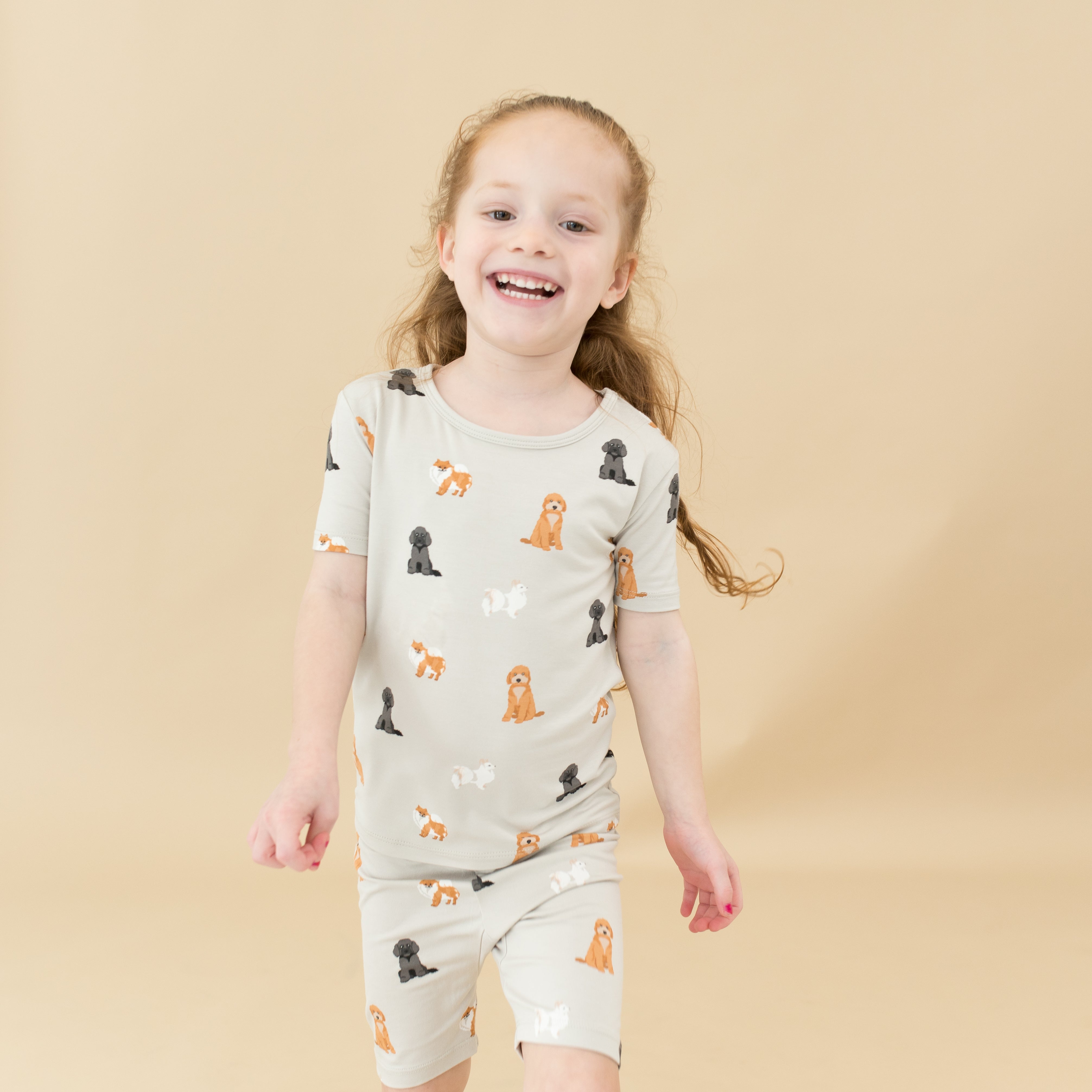 Child modeling Short Sleeve Pajamas in Fluffy Dog close up
