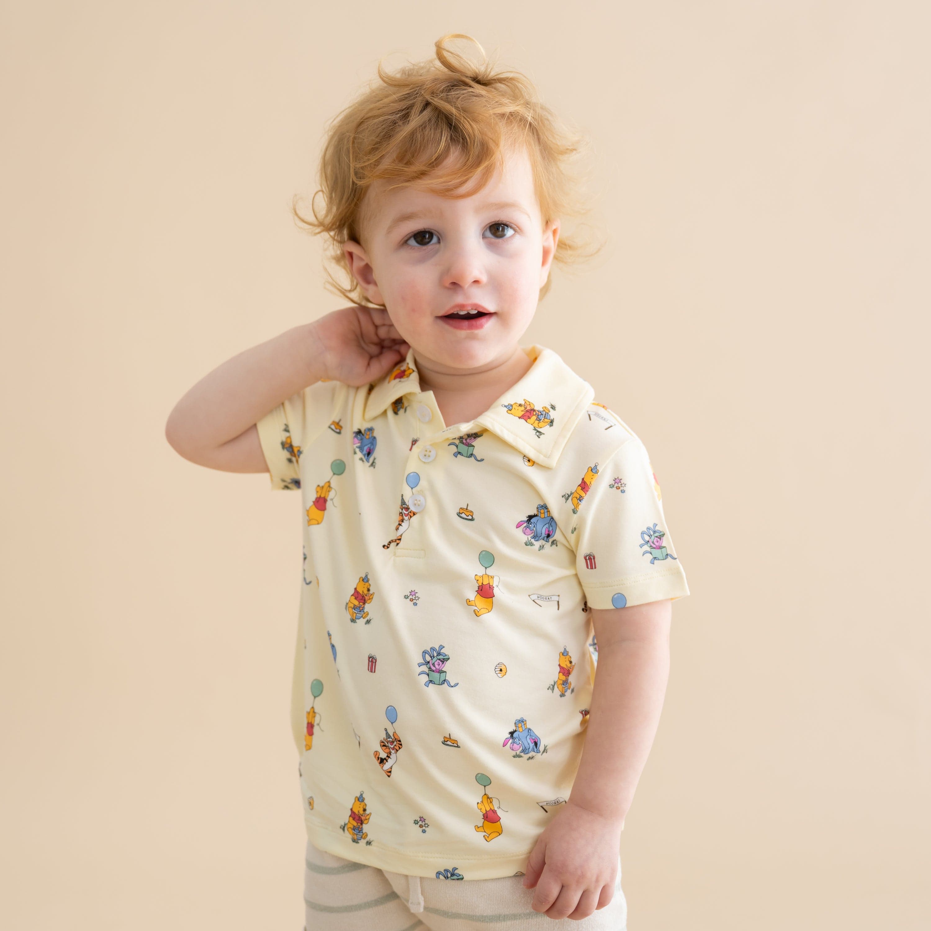Young boy posing wearing the standing in front of a light neutral background