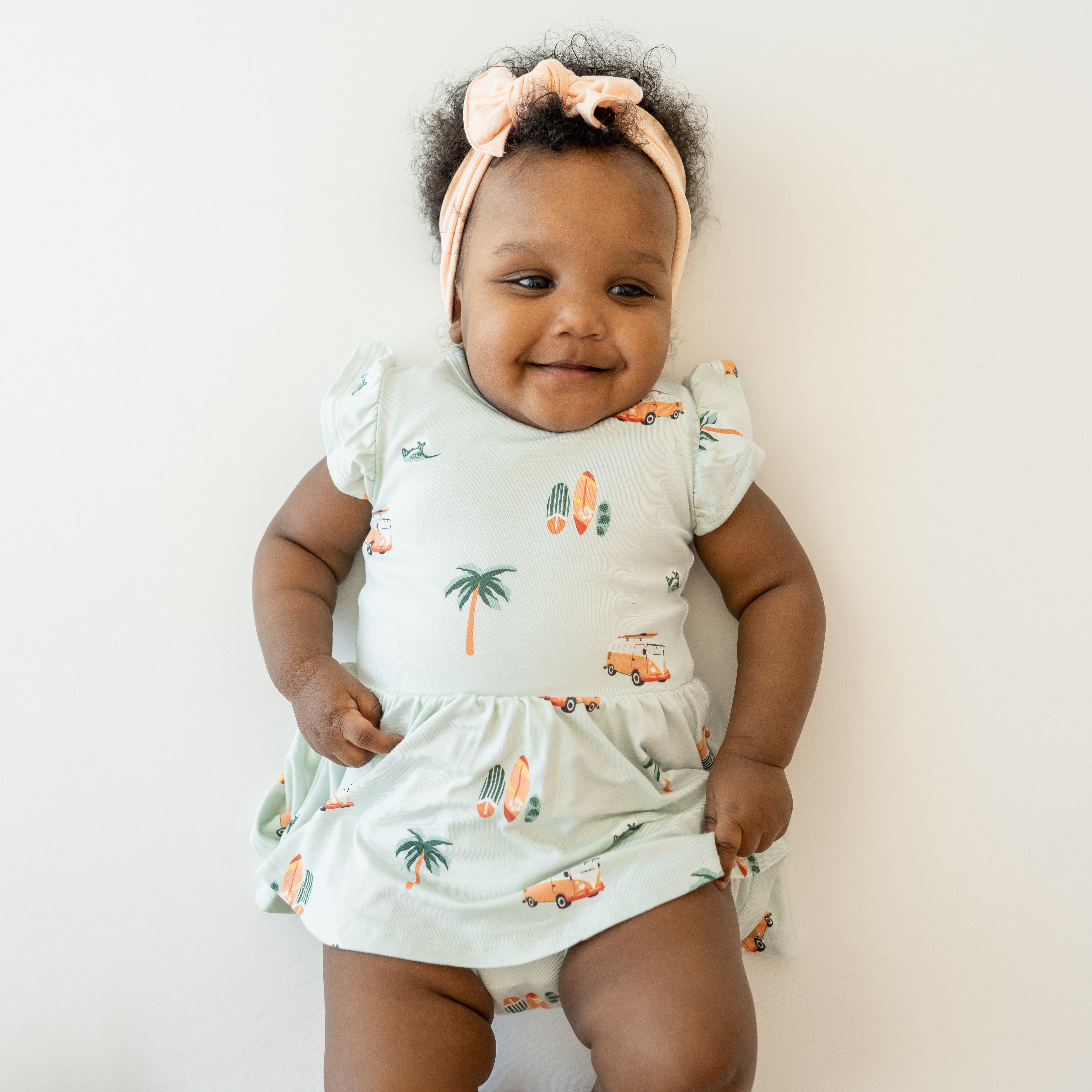 Baby wearing Twirl Bodysuit Dress in Dew Surf