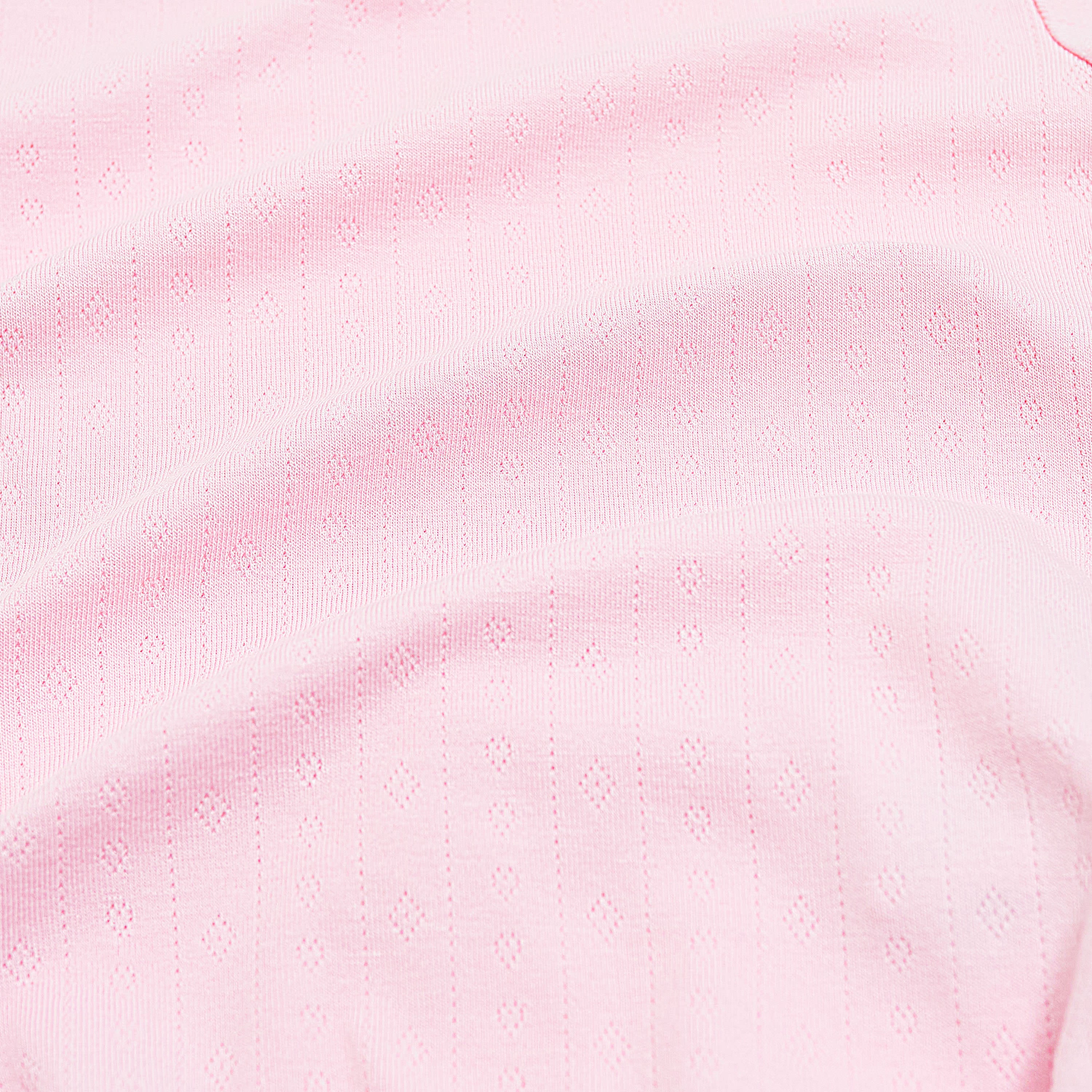 Close up of the pointelle fabric showing the light pink color