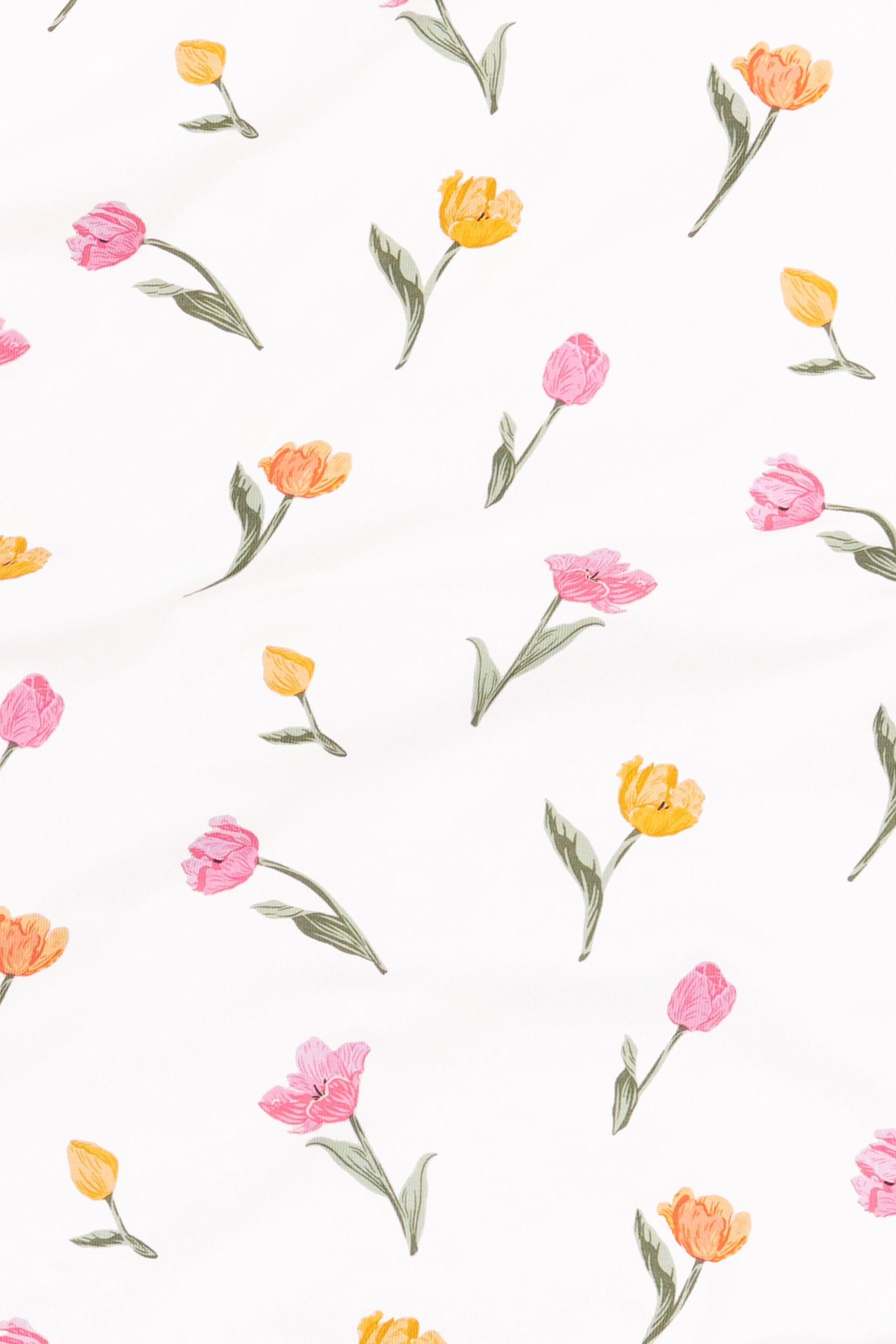 Close up of the fabric swatch of the print tulip showing the yellow, orange and pink tulips with green stems on a white background