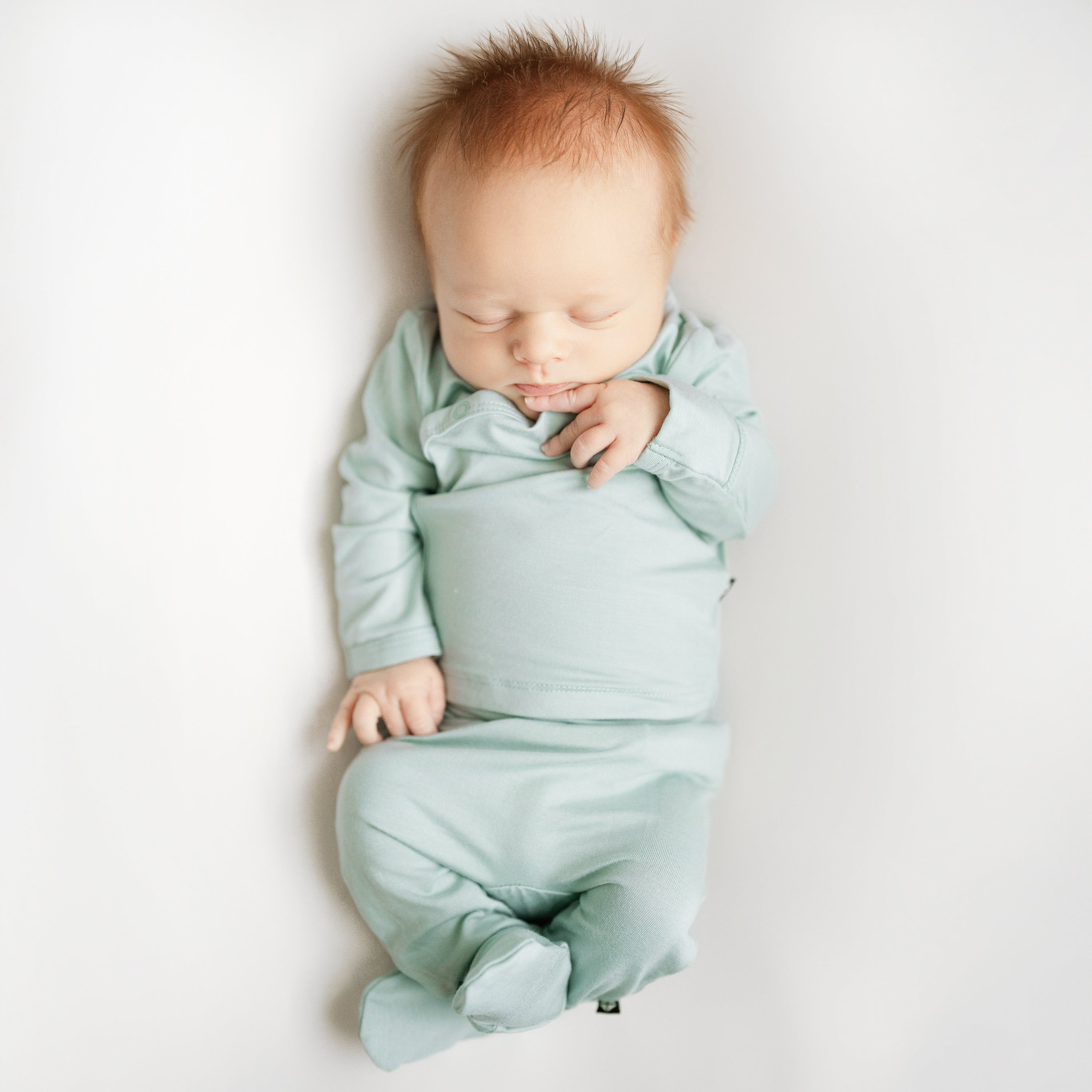 Sleeping newborn in Take Me Home Set in Sage