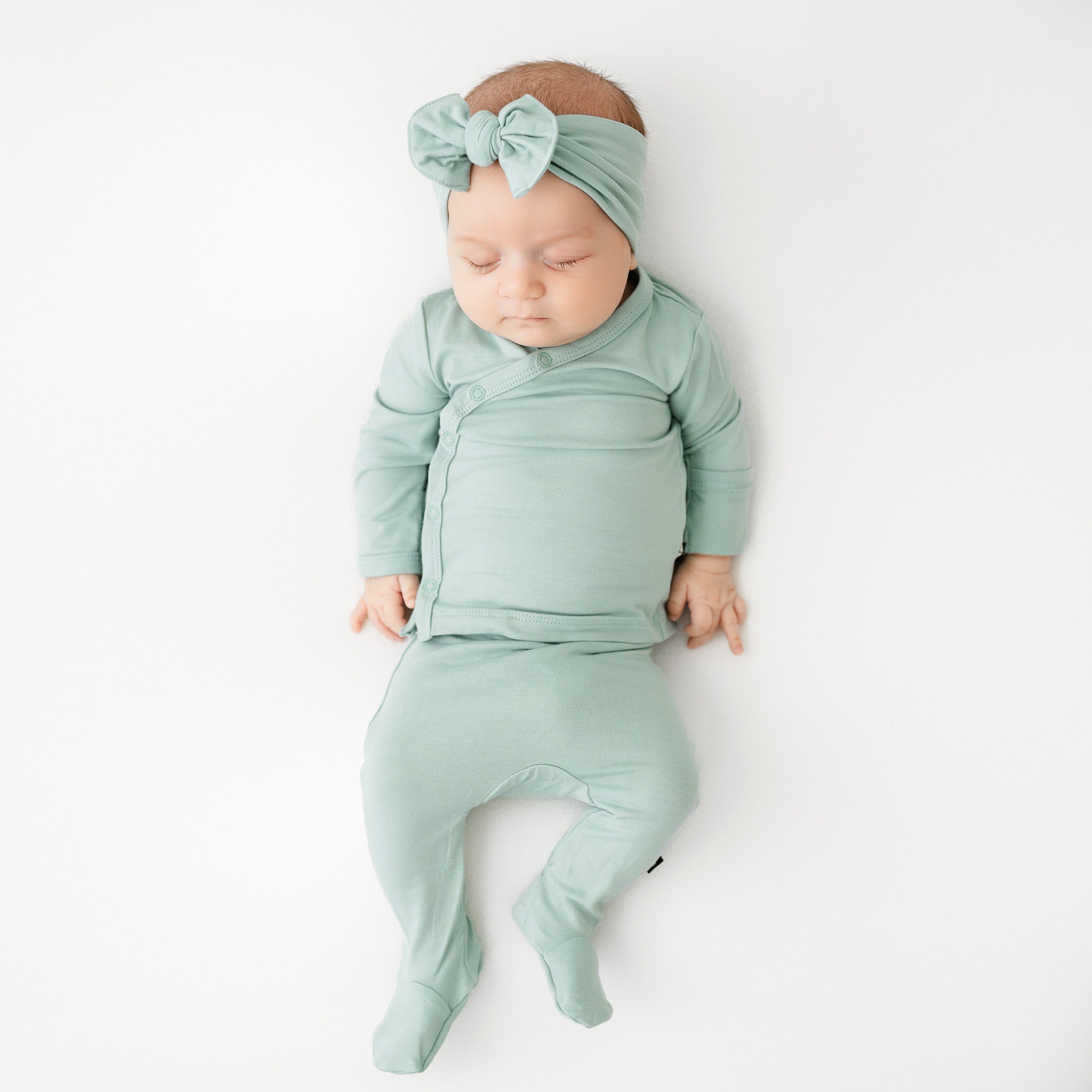 Baby sleeping in Take Me Home Set with Bow in Sage