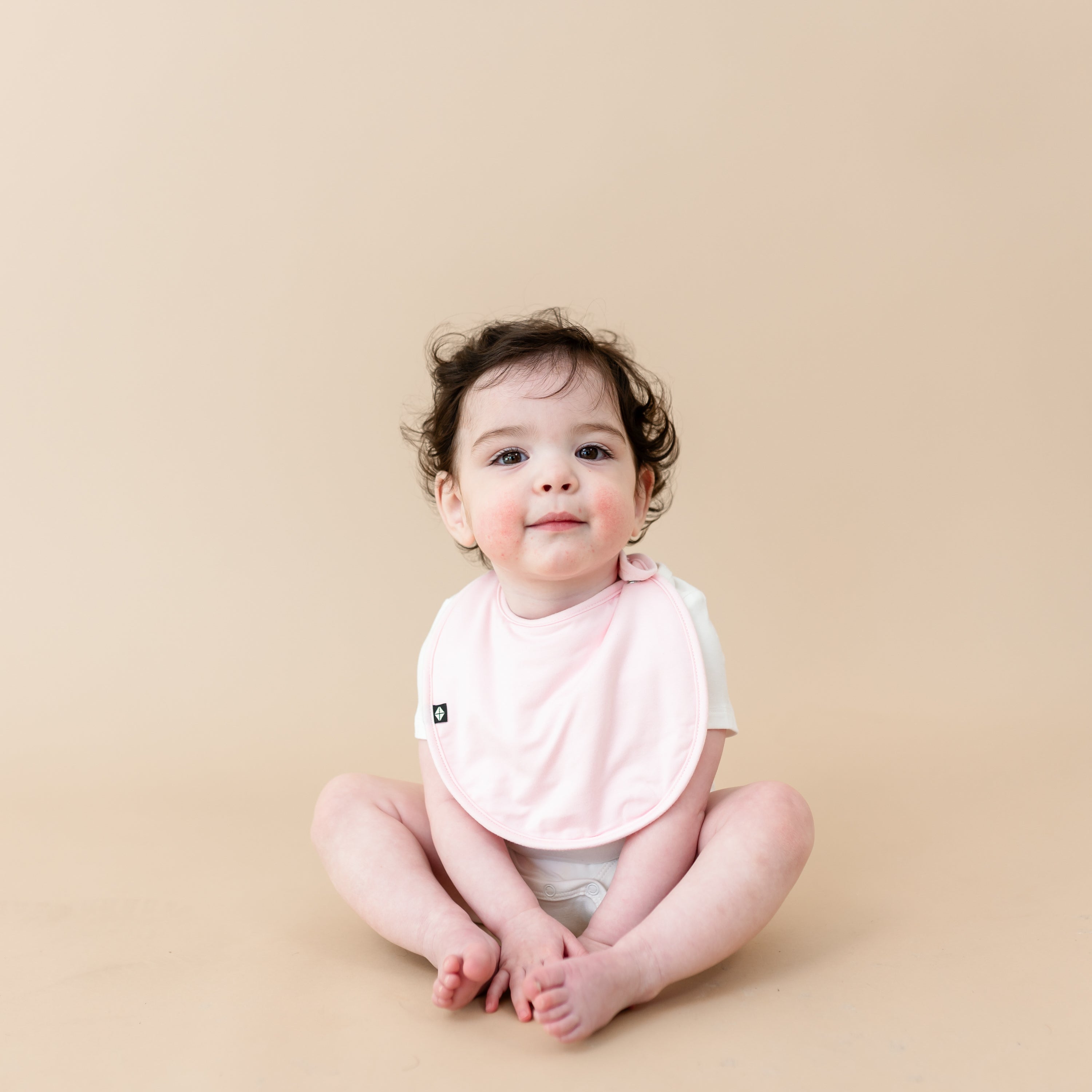 Cushy Bib in Sakura Pink on Baby