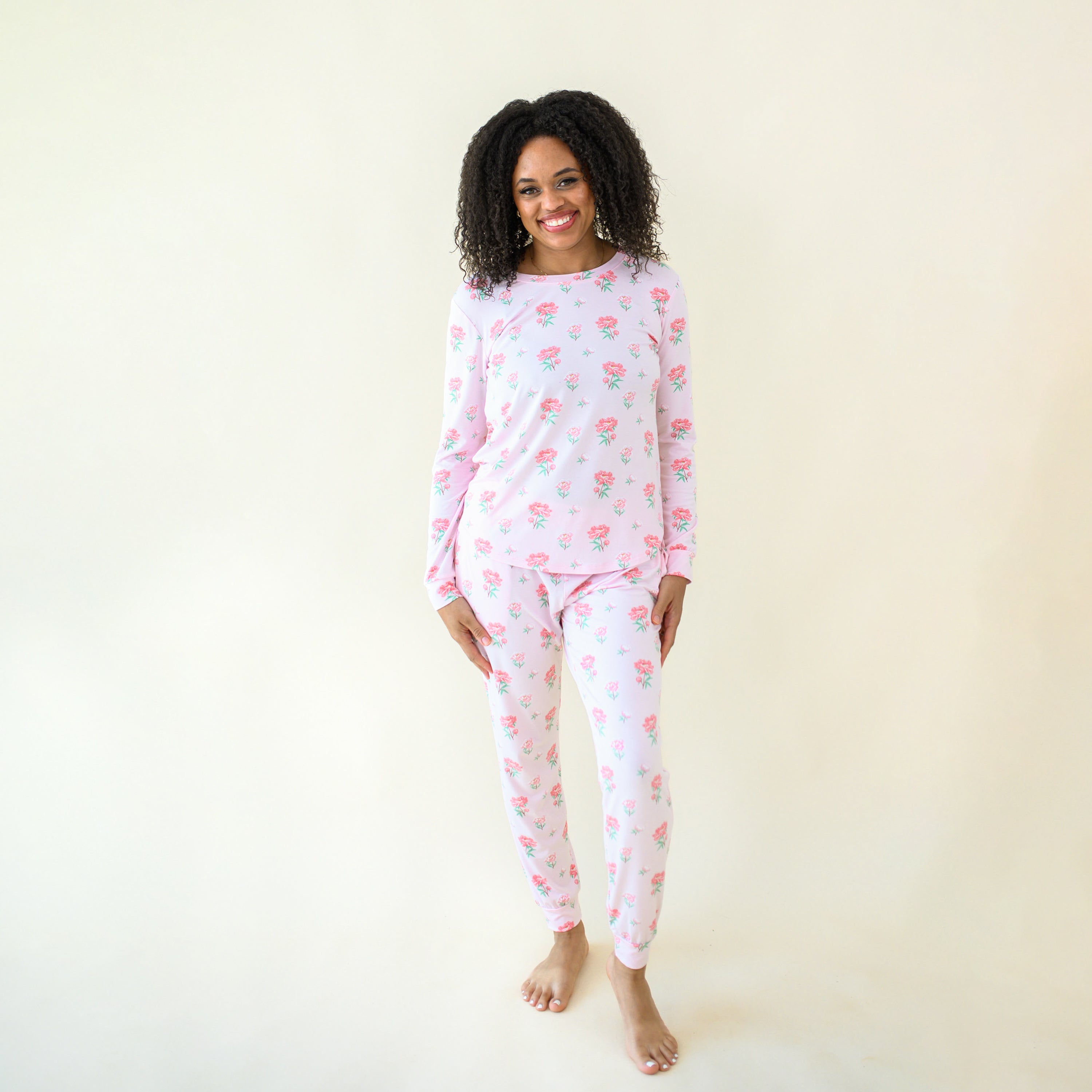 Smiling model wearing the Women's Jogger Pajama Set in Sakura Peony