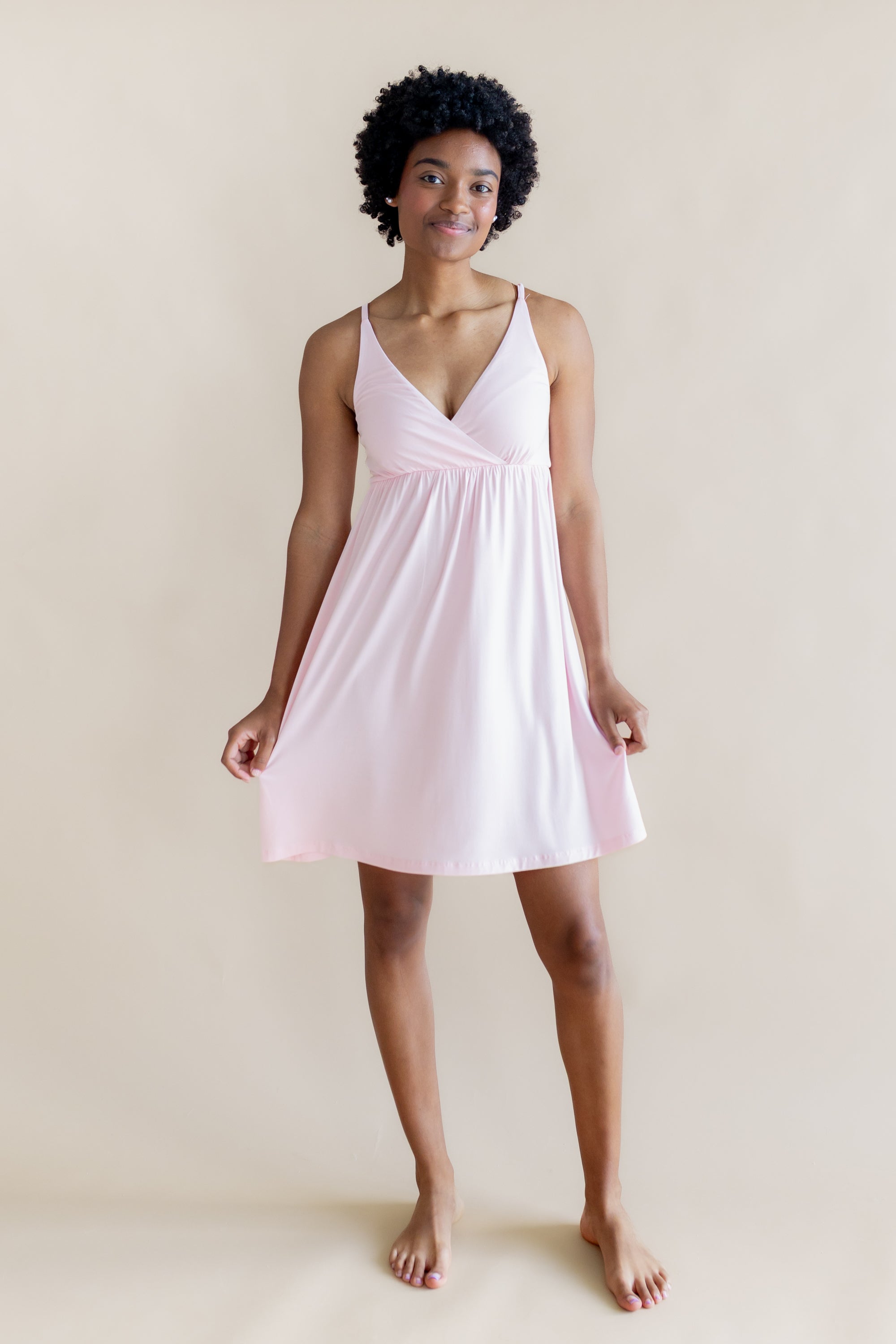 Female modeling the Women's Nightgown in Sakura holding the hem of the dress out with both hands