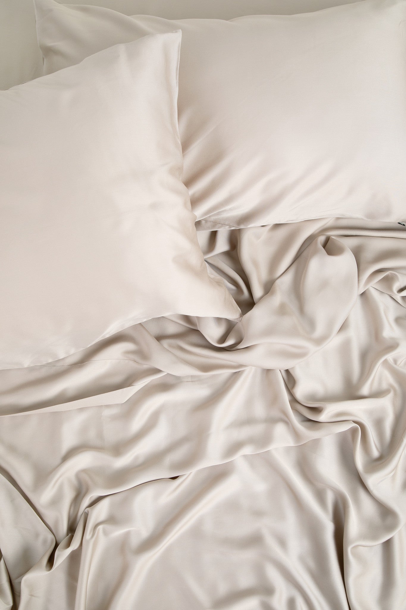 Close up of the Bamboo Sateen Sheet Set in Sand Stone shown on a bed