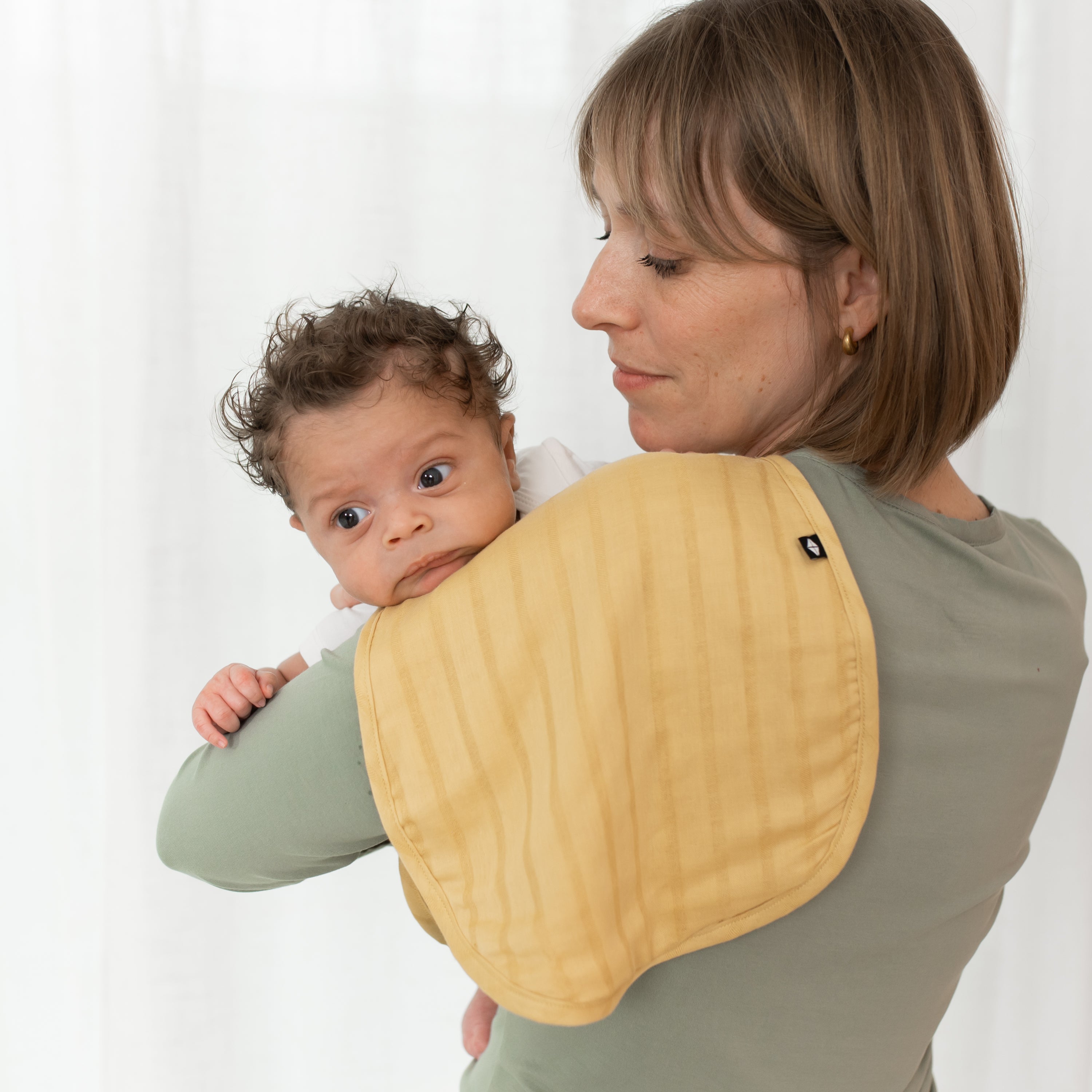 Mom Holding Baby with Bamboo Muslin Burp Cloth in Sandcastle Yellow