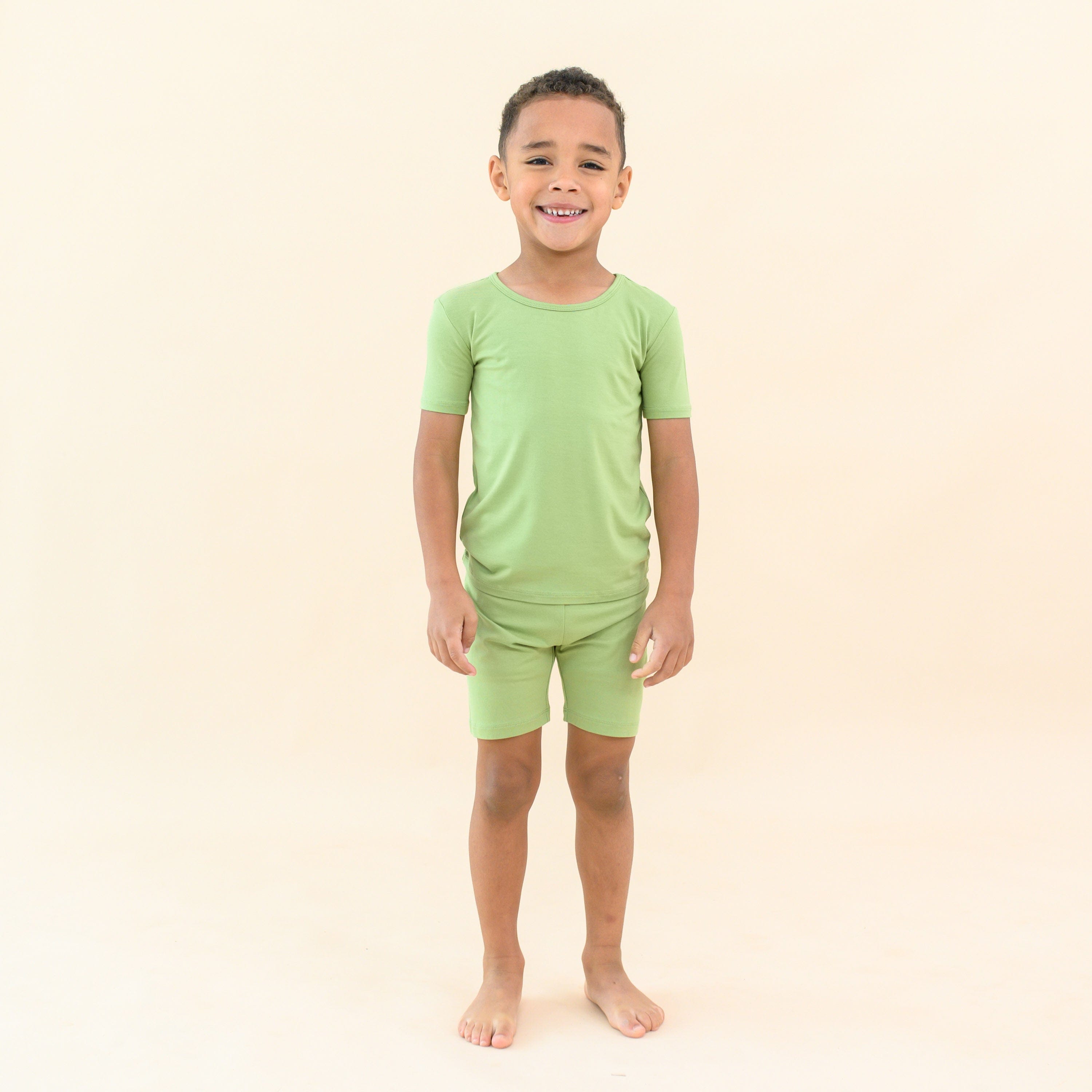 Toddler wearing Short Sleeve Kids Pajamas in honu green