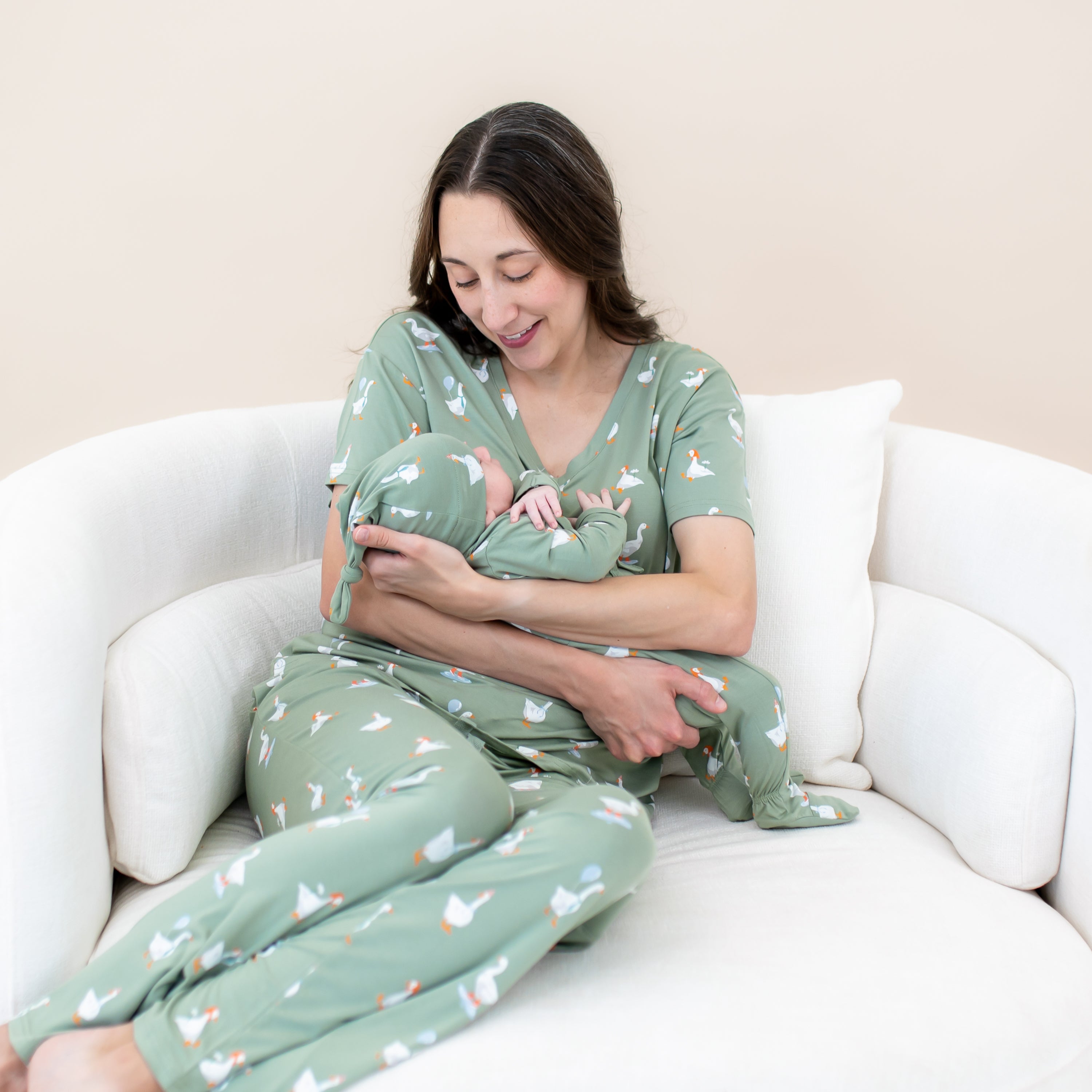 Mother and infant matching in Silly Goose sitting on a cream round sofa