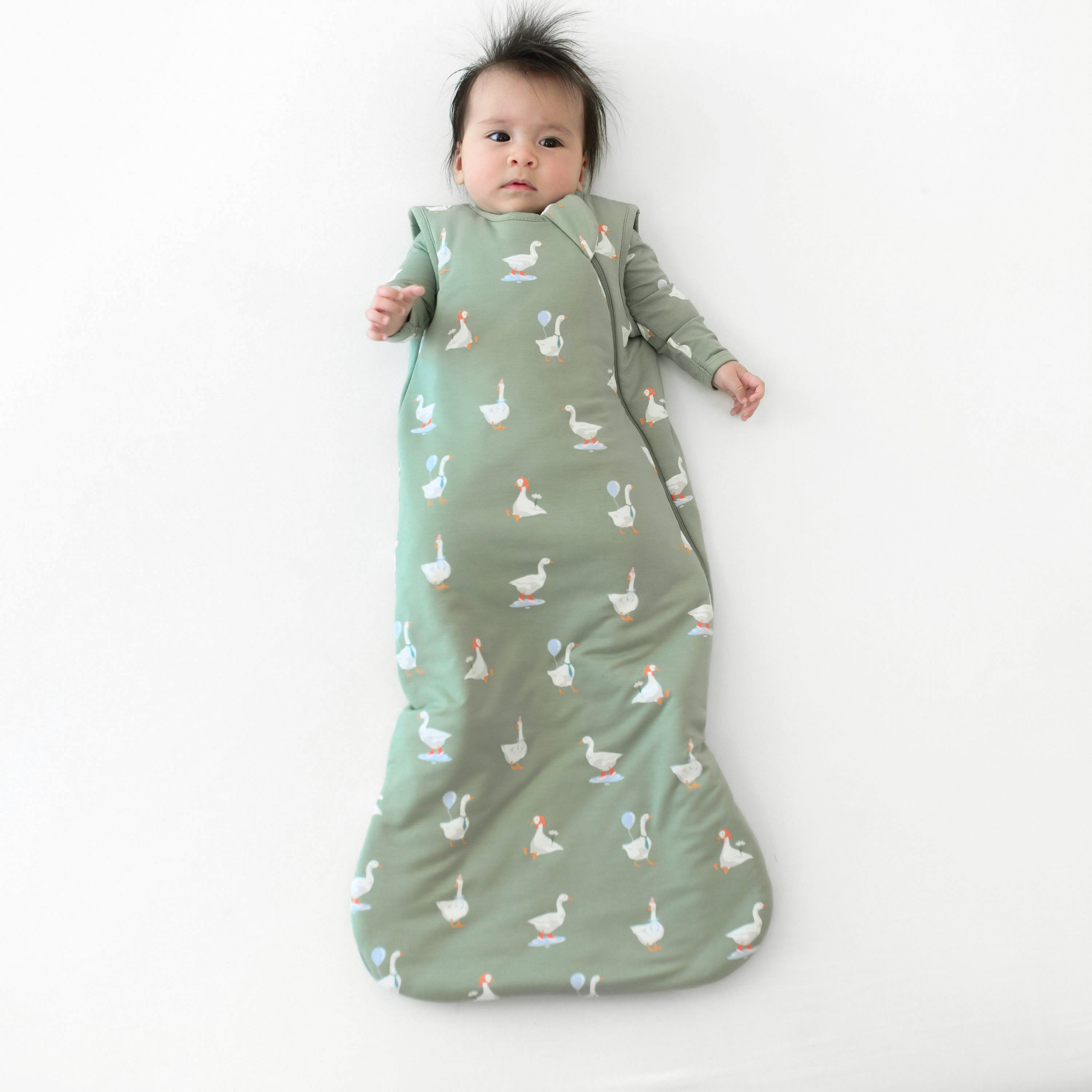Infant wearing TOG 1.0 Sleep Bag in Silly Goose over matching pajamas